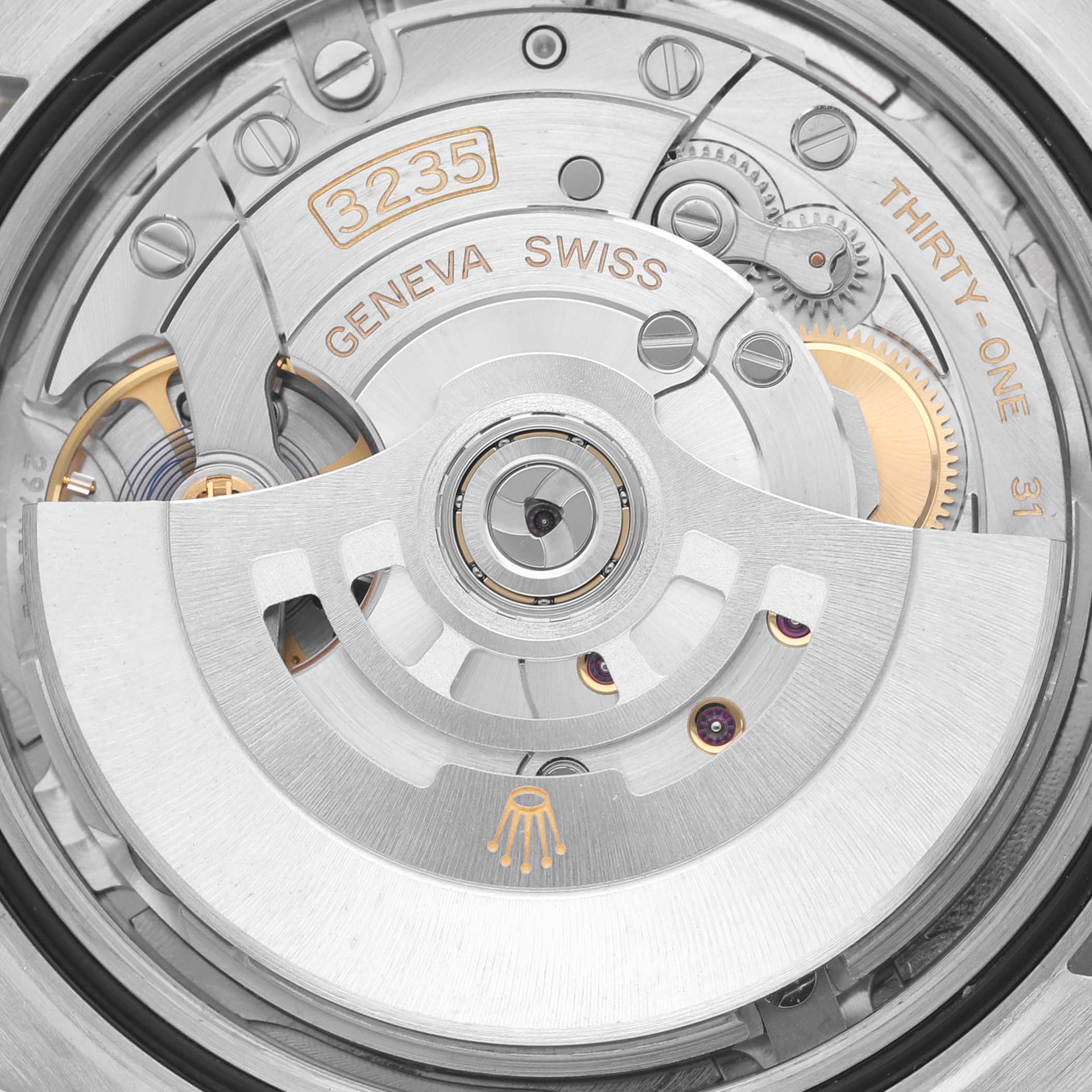 The image shows a close-up of the movement inside a Rolex Datejust 41 126331 Men's Steel and Gold (two tone) Pink Dial 126331 Men's Steel and Gold (two tone) Pink Dial, highlighting the intricate gears and rotor.
