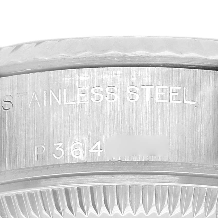 The image shows a close-up of the side and flange of a Rolex Datejust 79174 Women
s Stainless Steel Black Dial 79174 Women
s Stainless Steel Black Dial, highlighting the stainless steel engravings.