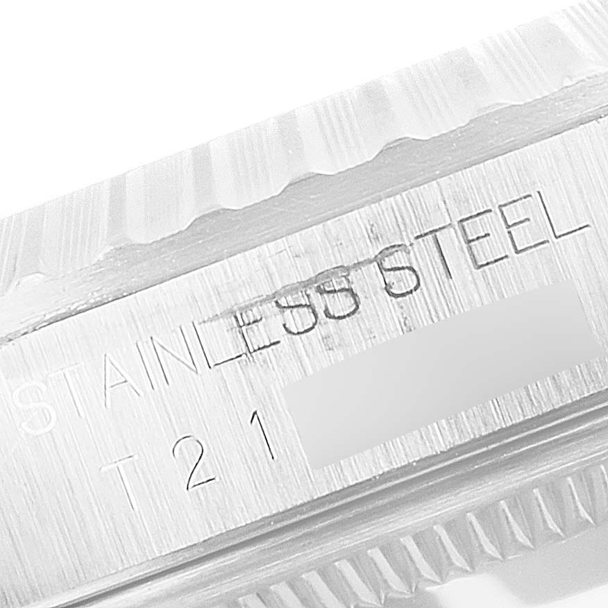 Close-up of the serial number and "STAINLESS STEEL" engraving on the side of a Rolex Datejust 16220 Men's Stainless Steel Silver Dial 16220 Men's Stainless Steel Silver Dial watch bezel.