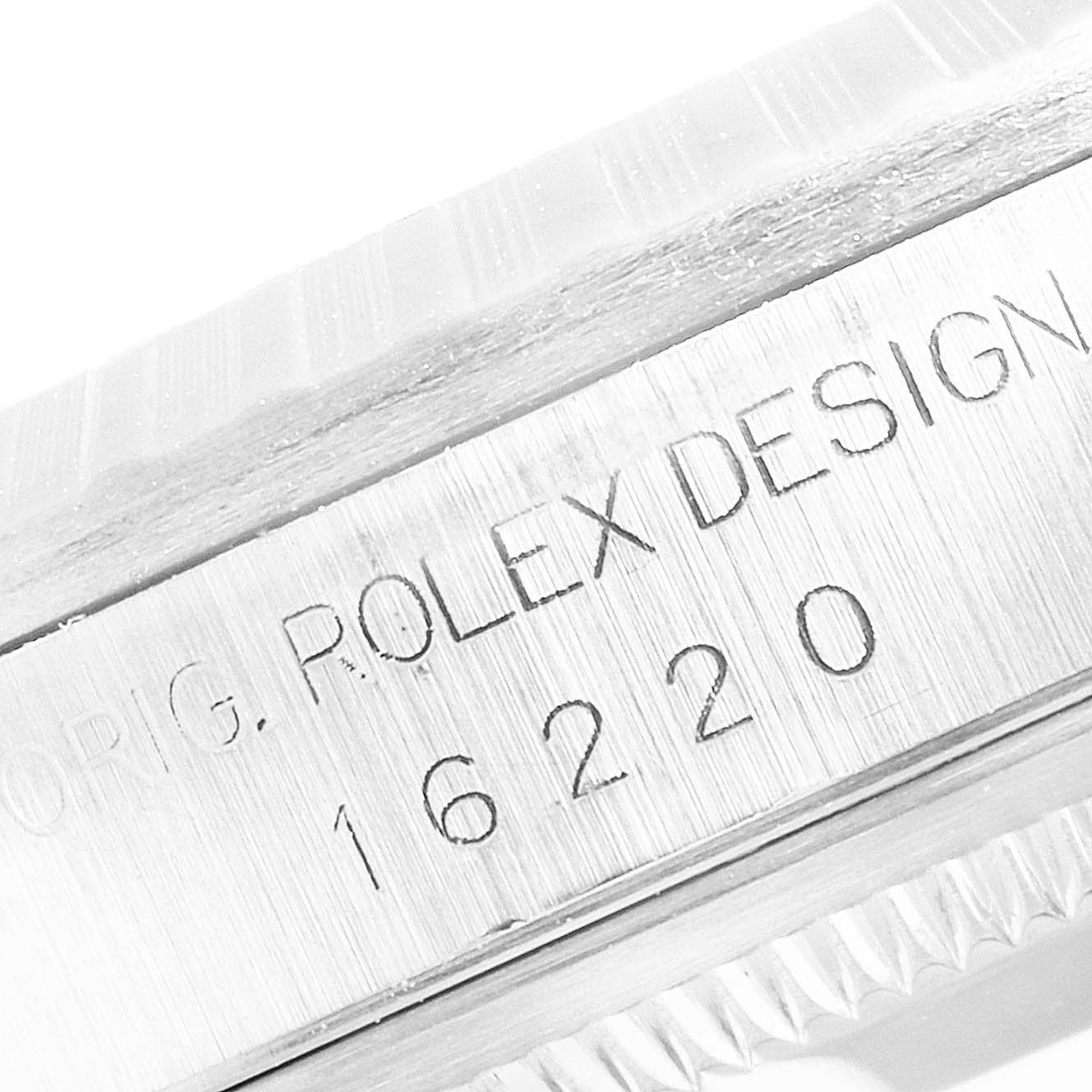 The image shows a close-up of the engraving on the side of the case of the Rolex Datejust 16220 Men's Stainless Steel Silver Dial 16220 Men's Stainless Steel Silver Dial model.