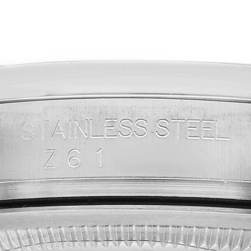 The image shows a close-up of the side engraving on the stainless steel case of a Rolex Datejust 116200 Men's Stainless Steel Black Dial watch.