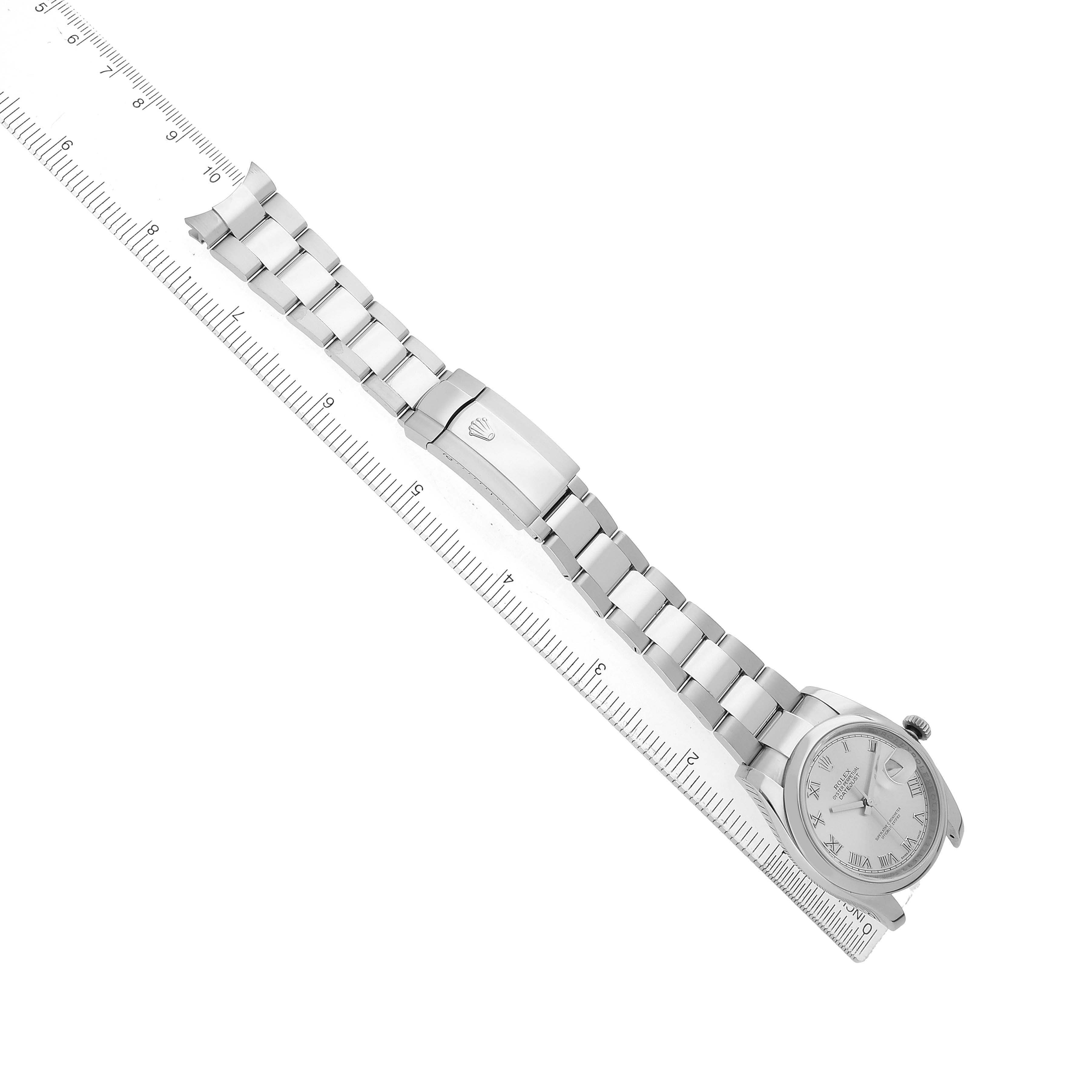 The Rolex Datejust 116200 Men's Stainless Steel Silver Dial watch is shown laid flat with the dial, bracelet, and clasp visible alongside a ruler for scale.