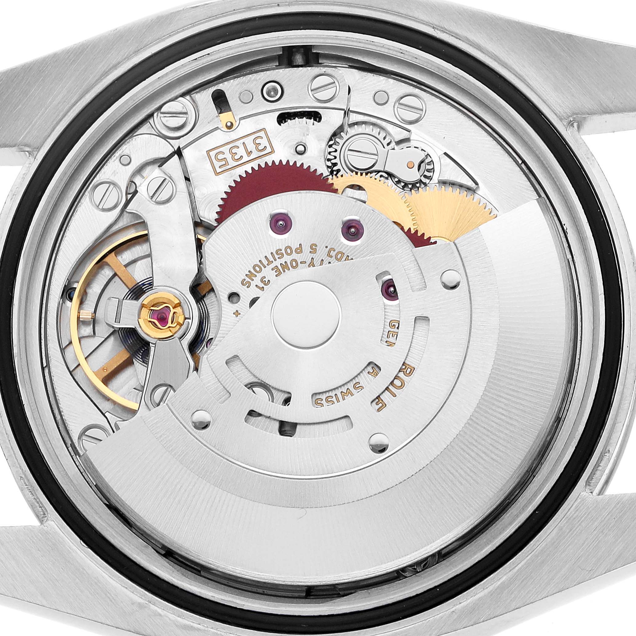 This image shows the Rolex Datejust 116200 Men's Stainless Steel Silver Dial's internal mechanism from the back, featuring the rotor, gears, and other movement components.