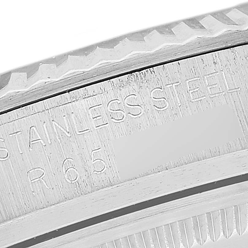 This close-up image shows the side view of the bezel and case of a Vintage Collection Rolex watch.