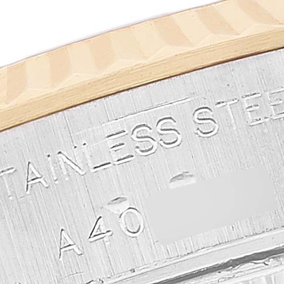 The image shows a close-up of the side of a Rolex Datejust 79173 Women's Steel and Gold (two tone) Champagne Dial 79173 Women's Steel and Gold (two tone) Champagne Dial model watch, highlighting the stainless steel and the fluted bezel.