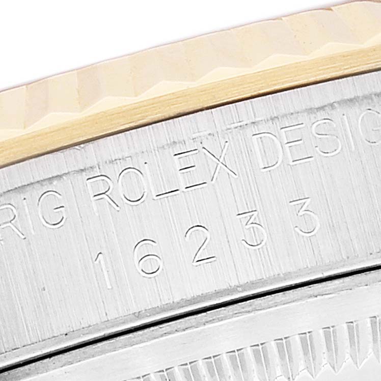 This close-up image shows the engraved case back and fluted bezel of a Rolex Datejust 16233 Men's Steel and Gold (two tone) Black Dial 16233 Men's Steel and Gold (two tone) Black Dial watch.