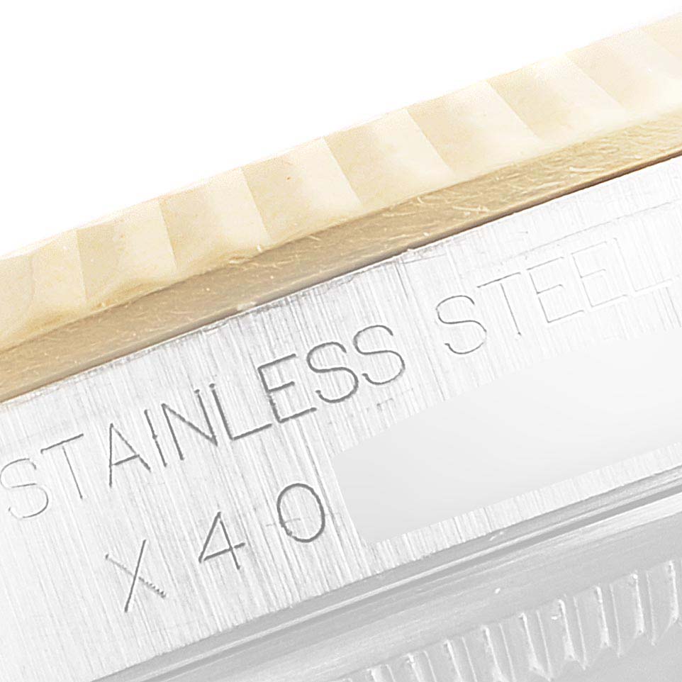 This image shows a close-up angle of the bezel and case of a Rolex Datejust 16233 Men's Steel and Gold (two tone) Champagne Dial 16233 Men's Steel and Gold (two tone) Champagne Dial watch, highlighting the stainless steel engraving.