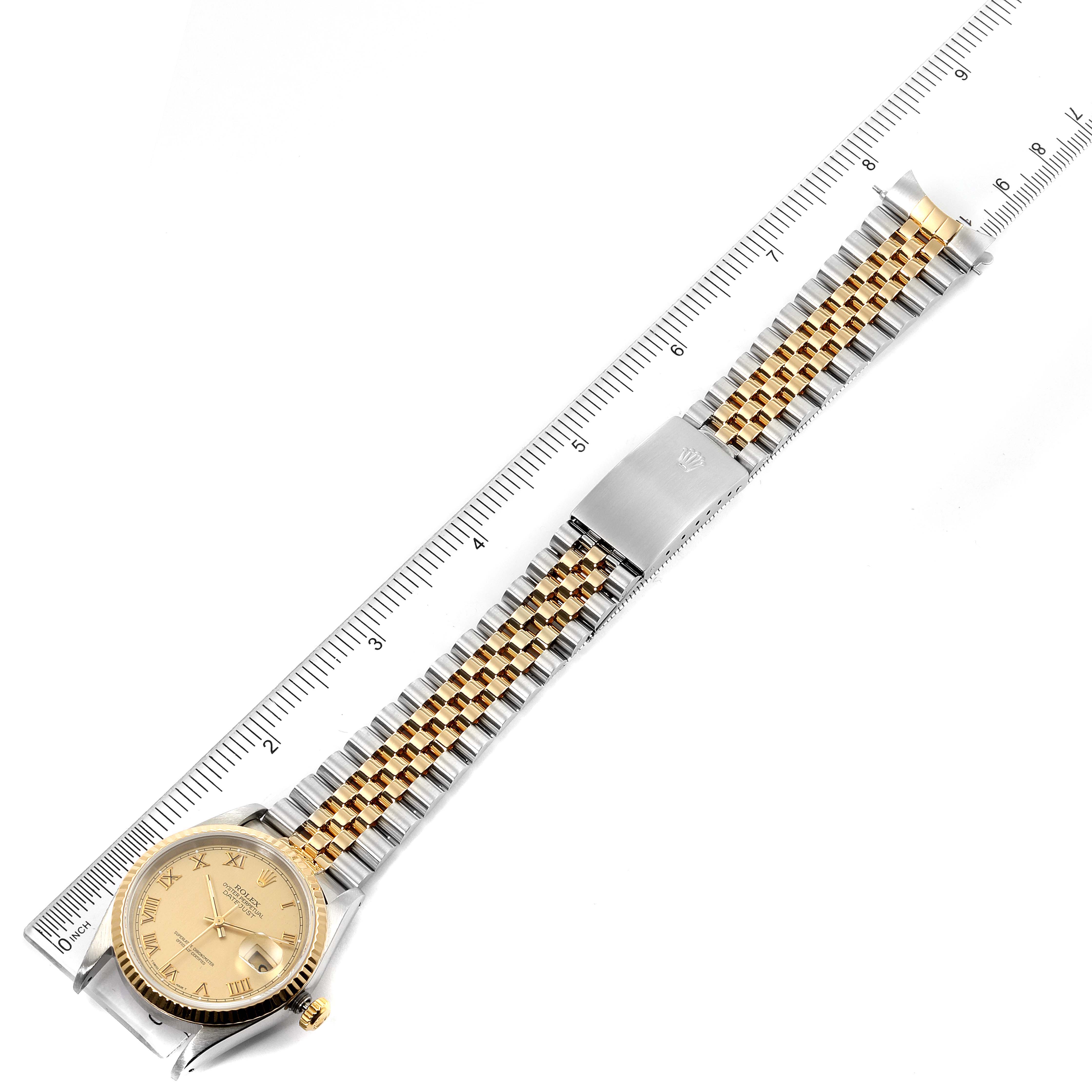 The image shows a top-down view of a Rolex Datejust 16233 Men's Steel and Gold (two tone) Champagne Dial 16233 Men's Steel and Gold (two tone) Champagne Dial watch with its bracelet extended and a ruler for scale.