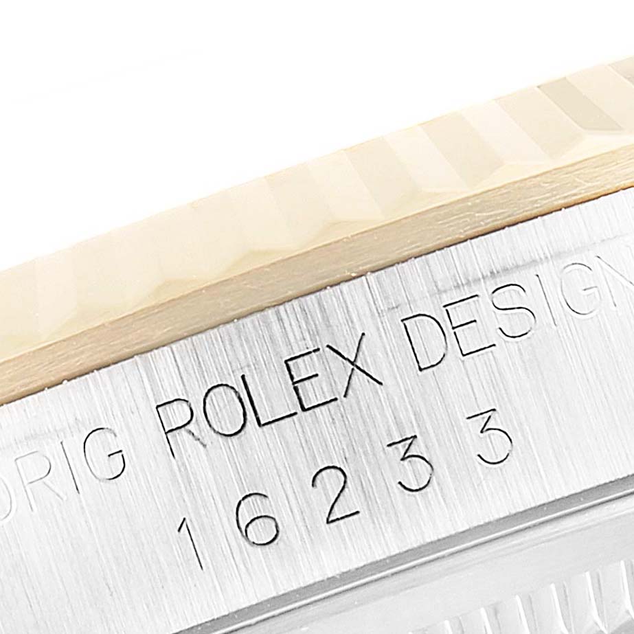 The image shows a close-up of the side of a Rolex Datejust 16233 Men's Steel and Gold (two tone) Champagne Dial 16233 Men's Steel and Gold (two tone) Champagne Dial watch, highlighting the model number and the Rolex design engraving.