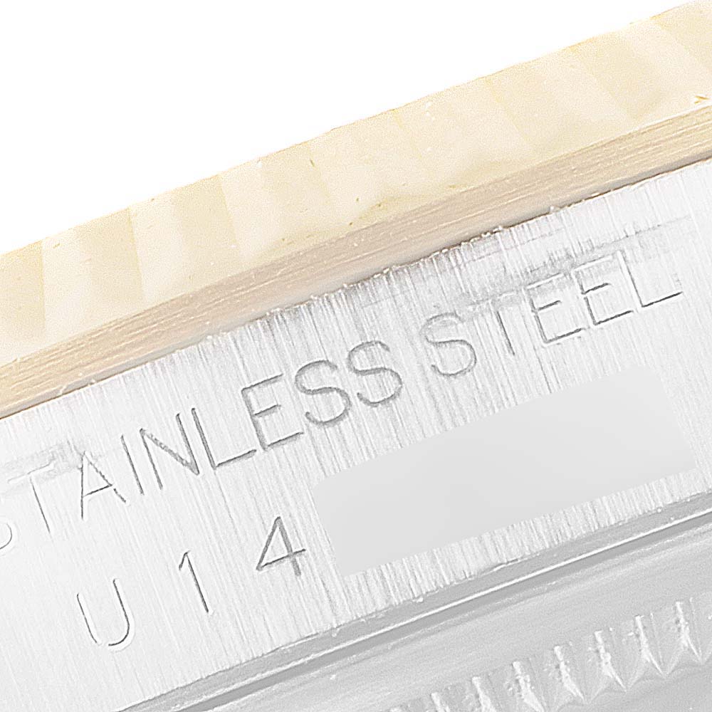 This image shows a close-up of the stainless steel case and fluted bezel of a Rolex Datejust 16233 Men's Steel and Gold (two tone) Champagne Dial 16233 Men's Steel and Gold (two tone) Champagne Dial watch.