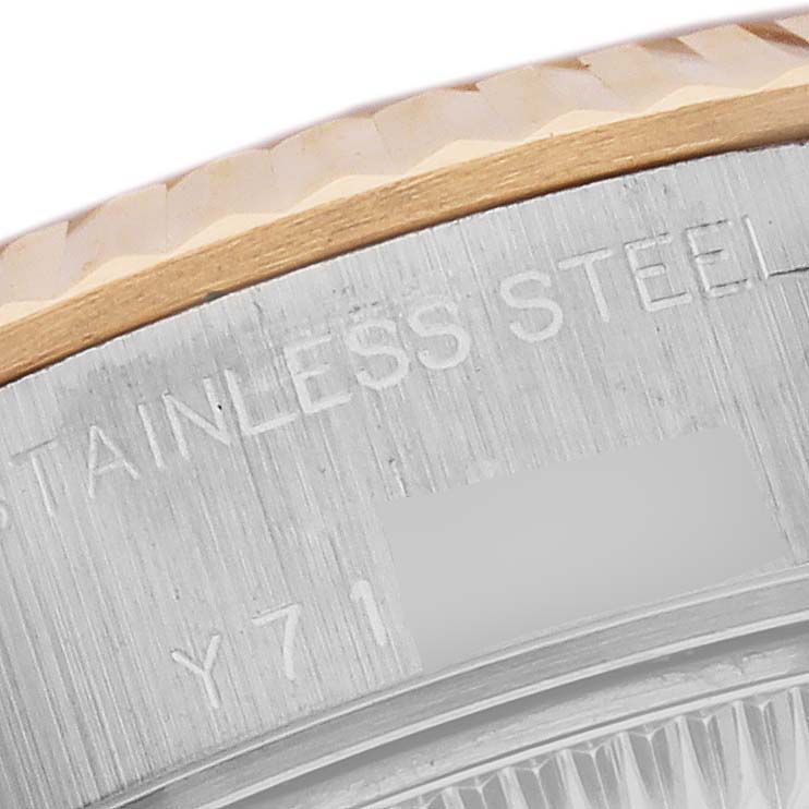 The image shows a close-up of the side edge of a Rolex Datejust 79173 Women's Steel and Gold (two tone) White Dial 79173 Women's Steel and Gold (two tone) White Dial watch, highlighting the stainless steel and fluted bezel.