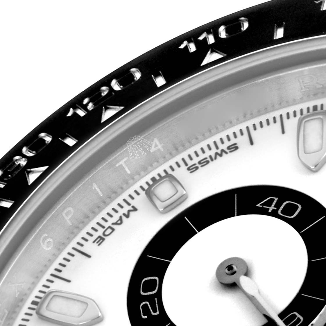 The image shows a close-up of the Rolex Daytona 116500LN Men's Stainless Steel White Dial 116500LN Men's Stainless Steel White Dial's bezel and part of its dial, focusing on the tachymetric scale and hour indices.