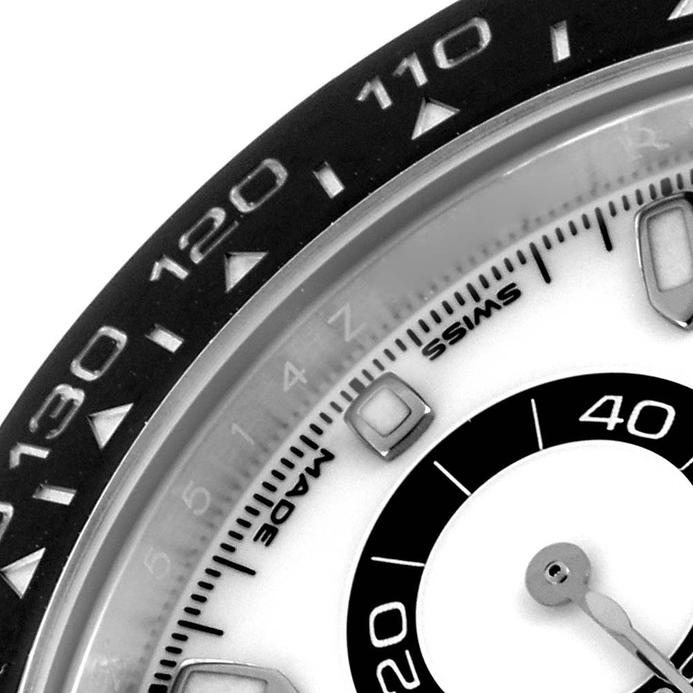 The image shows a close-up of the Rolex Daytona 116500LN Men's Stainless Steel White Dial 116500LN Men's Stainless Steel White Dial watch's bezel and partial dial.