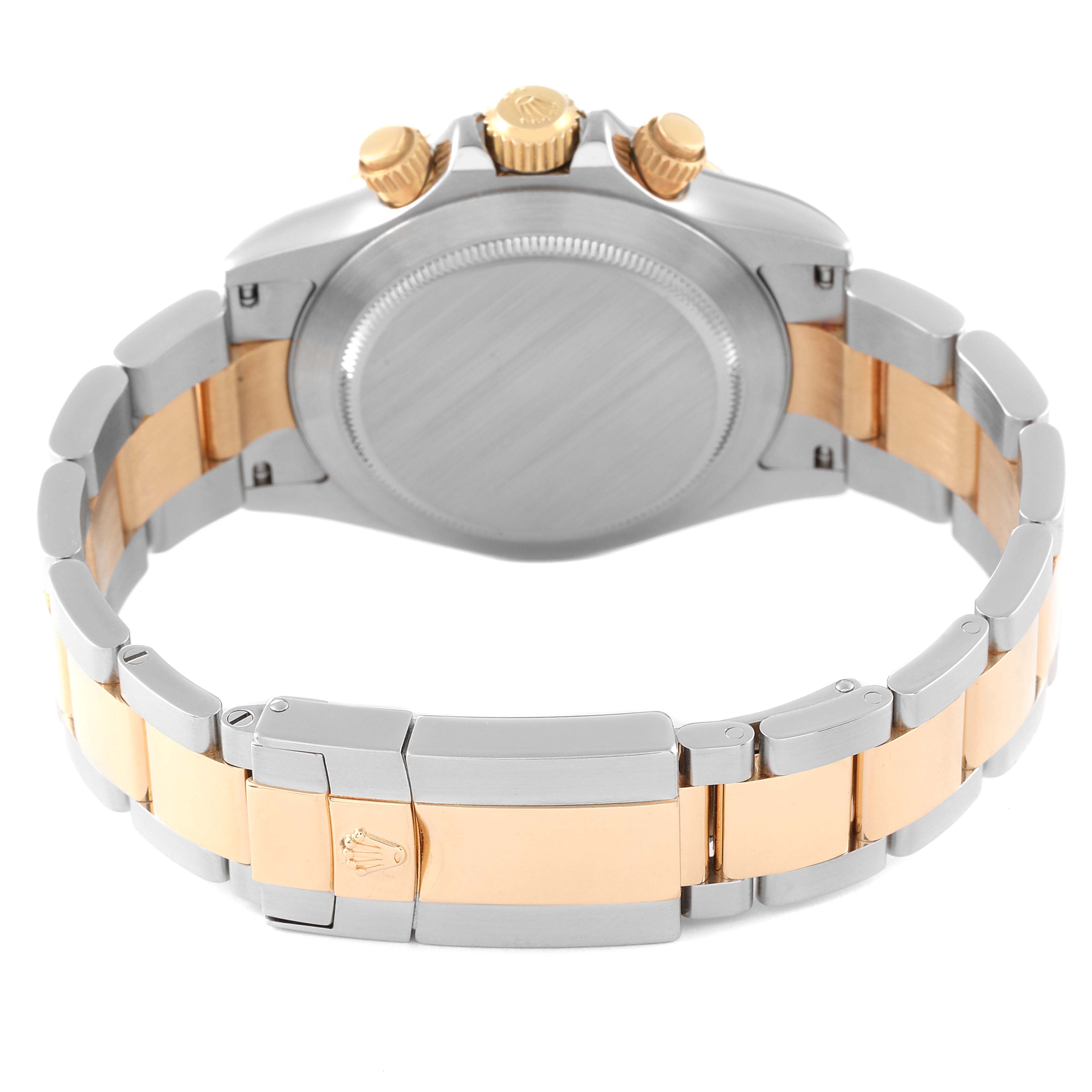 This image shows the back and bracelet of a Rolex Daytona 116523 Men's Steel and Gold (two tone) Black Dial 116523 Men's Steel and Gold (two tone) Black Dial watch, highlighting the crown and clasp.