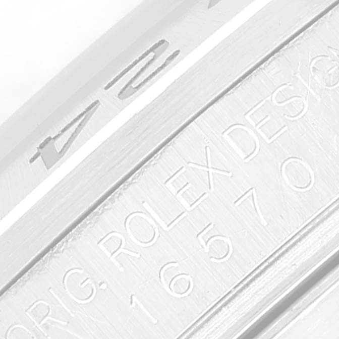 The image shows a close-up of the engraved details on the bezel and case side of a Rolex Explorer 16570 Men
s Stainless Steel Black Dial 16570 Men
s Stainless Steel Black Dial model.