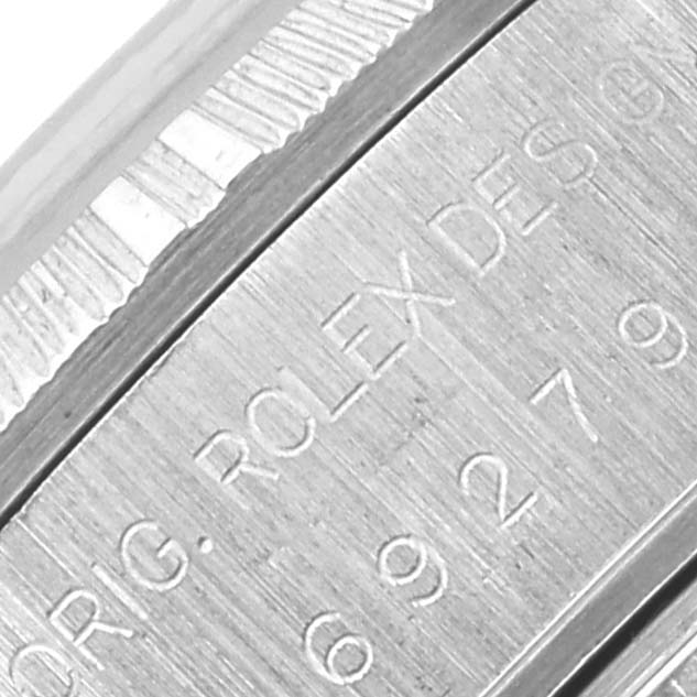The image shows a close-up of the engraved side of the Rolex President 69278 Women's White Gold Pink Dial 69278 Women's White Gold Pink Dial model, highlighting the edge and some text details.