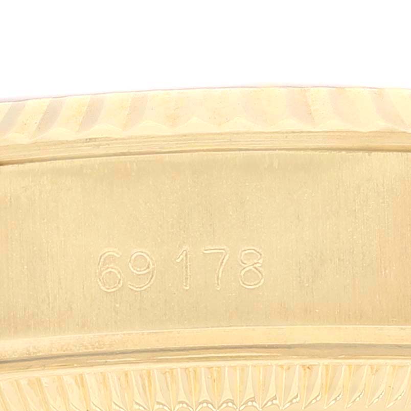 This close-up image shows the side of a Rolex President 69178 Women
s Yellow Gold Champagne Dial 69178 Women
s Yellow Gold Champagne Dial model watch with the reference number 69178 engraved.