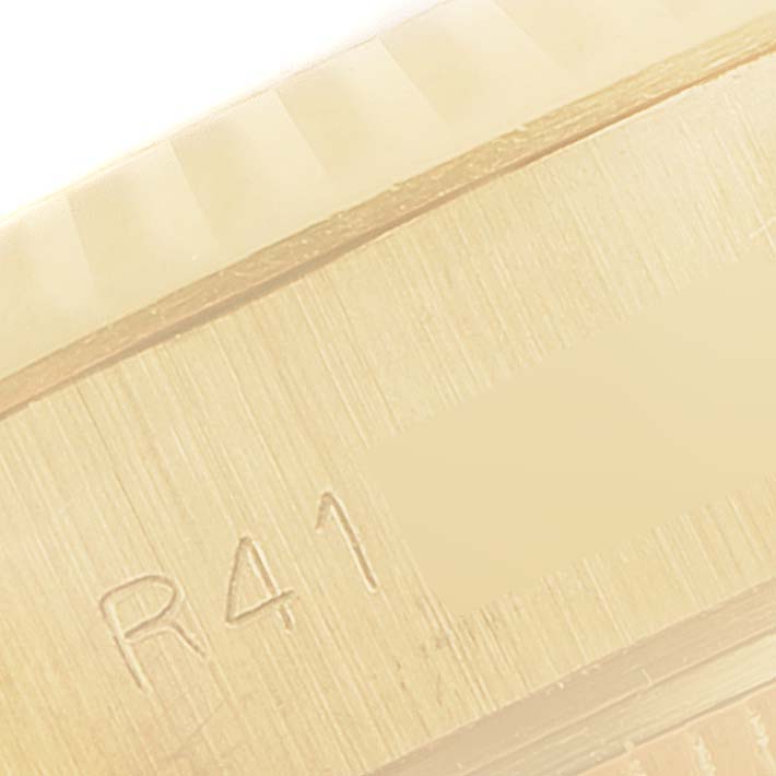 This close-up image shows part of the bezel and engraved detail of a Rolex President 69178 Women
s Yellow Gold Champagne Dial 69178 Women
s Yellow Gold Champagne Dial model watch.