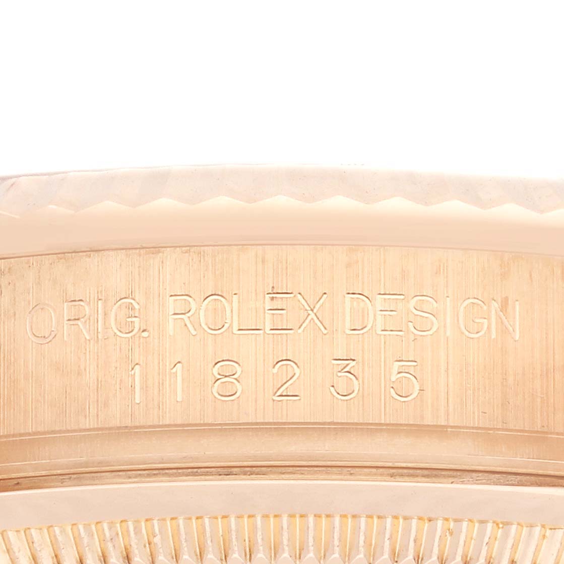 This image shows the side engraving of the case of a Rolex President 118235 Men
s Rose Gold Pink Dial 118235 Men
s Rose Gold Pink Dial model, displaying "ORIG. ROLEX DESIGN."