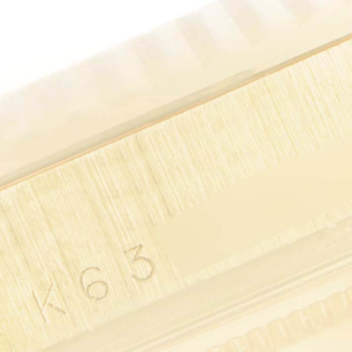 This image shows a close-up of a side portion of a Rolex President 118238 Men
s Yellow Gold Champagne Dial 118238 Men
s Yellow Gold Champagne Dial model watch with some engraving visible.