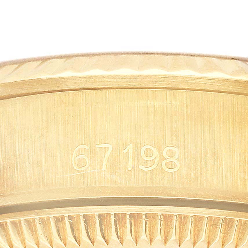 The image shows the engraved side of a Rolex President 67198 Women's Yellow Gold Champagne Dial 67198 Women's Yellow Gold Champagne Dial model, displaying its reference number.