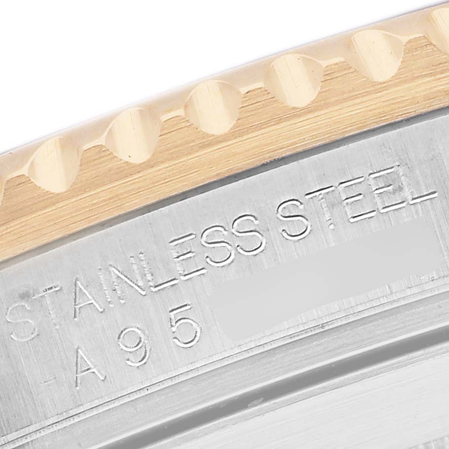 The image shows a close-up of a Rolex Submariner 16613 Men's Steel and Gold (two tone) Blue Dial's case back edge, highlighting the stainless steel engraving.