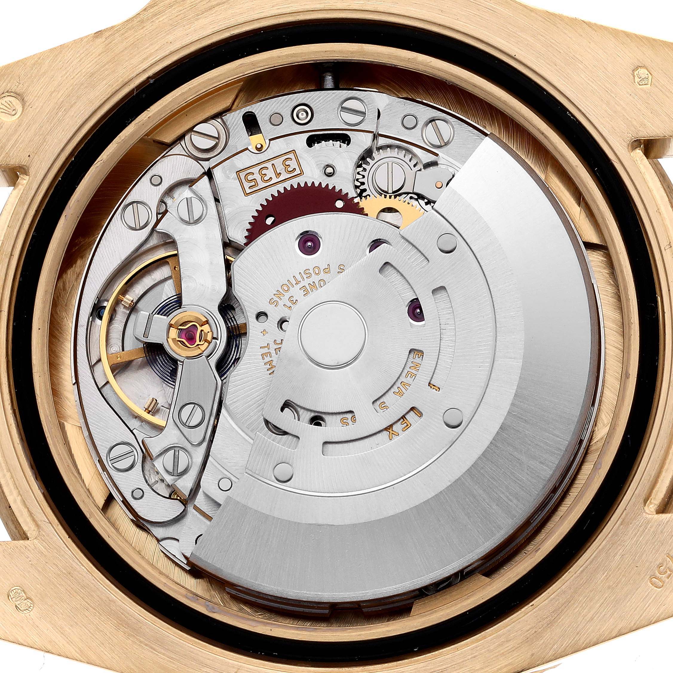 The image shows a detailed view of the Rolex Submariner 116618LB Men's Yellow Gold Blue Dial 116618LB Men's Yellow Gold Blue Dial movement from the back, highlighting gears and the rotor.