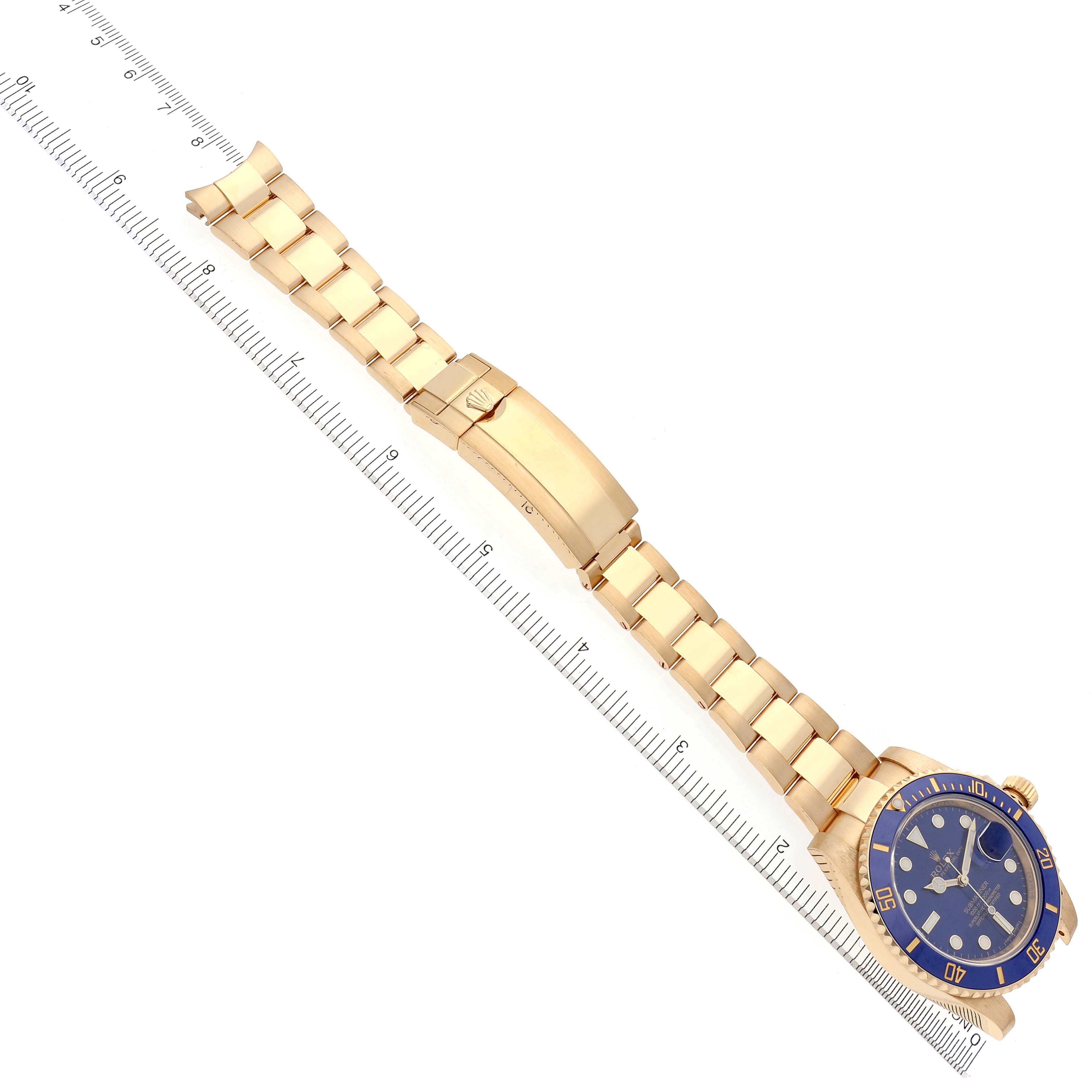 The image shows a Rolex Submariner 116618LB Men's Yellow Gold Blue Dial 116618LB Men's Yellow Gold Blue Dial watch laid flat, highlighting the gold bracelet and blue dial.