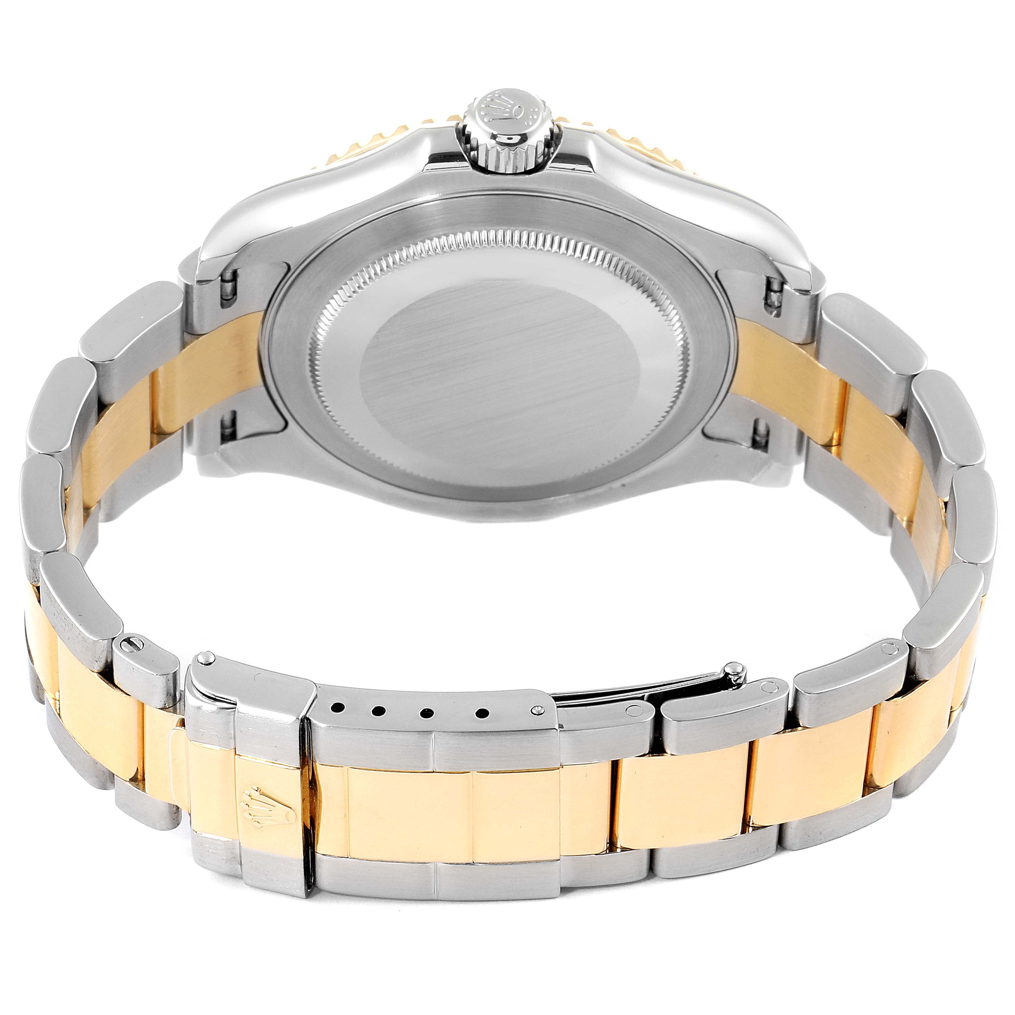 The image shows the back view of a Rolex Yacht-Master 16623 Men
s Steel and Gold (two tone) Champagne Dial 16623 Men
s Steel and Gold (two tone) Champagne Dial watch, highlighting its case, crown, and two-tone metal bracelet.