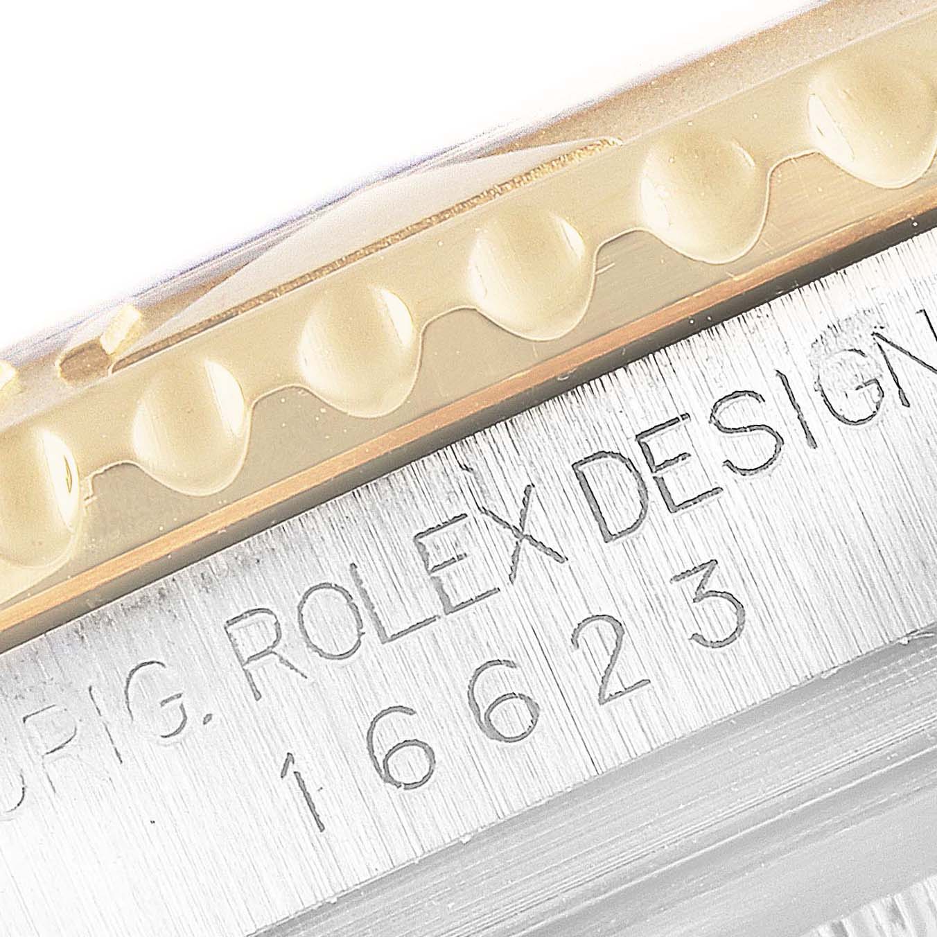 This close-up image shows the side of a Rolex Yacht-Master 16623 Men
s Steel and Gold (two tone) Champagne Dial 16623 Men
s Steel and Gold (two tone) Champagne Dial watch, highlighting the bezel and engraved case details.