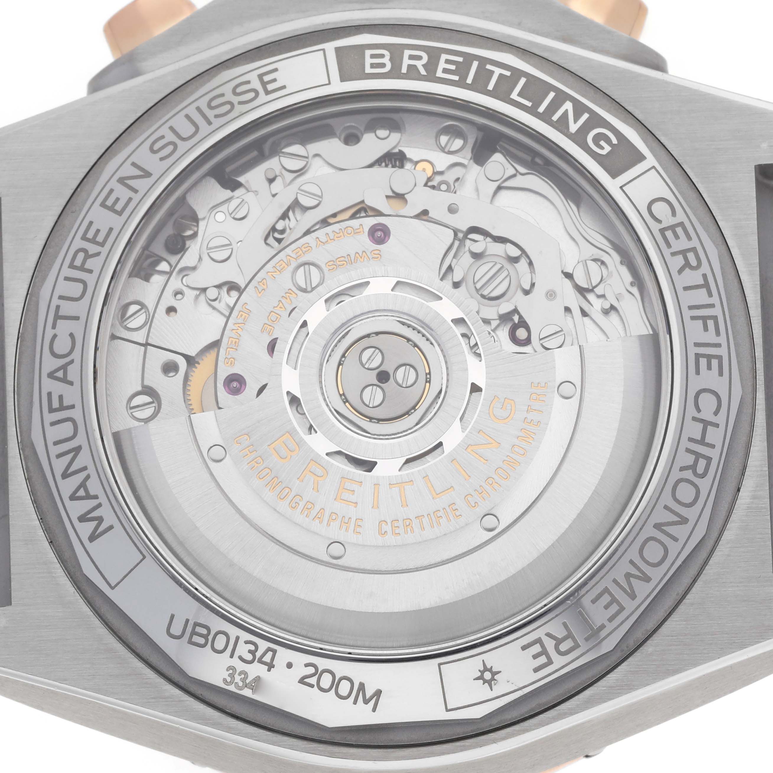 The image shows the back of the Breitling Chronomat UB0134 Men's Steel and Gold (two tone) Grey Dial watch, revealing its intricate inner mechanism.