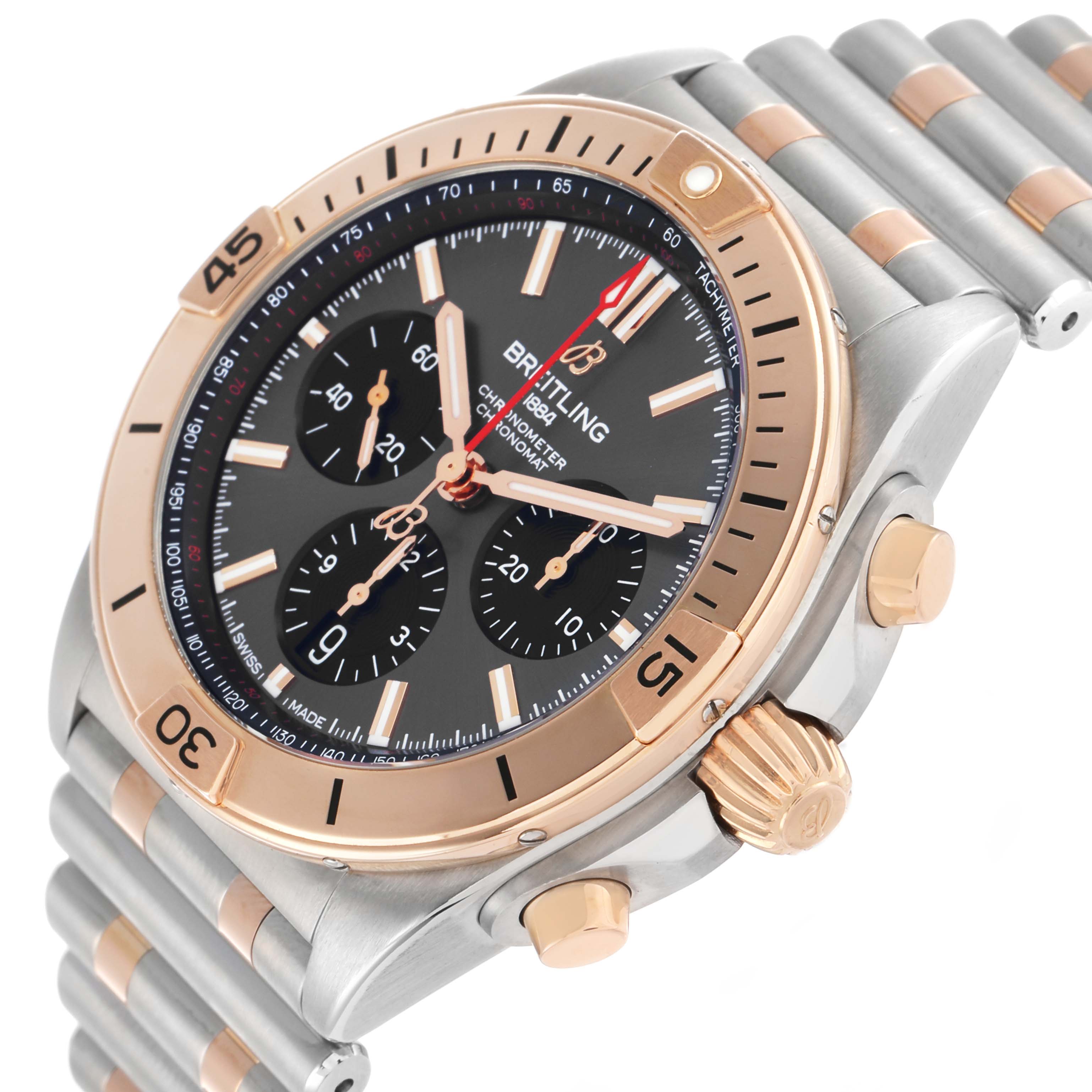 The Breitling Chronomat UB0134 Men's Steel and Gold (two tone) Grey Dial watch is shown from an angle highlighting the face, bezel, crown, and part of the bracelet.