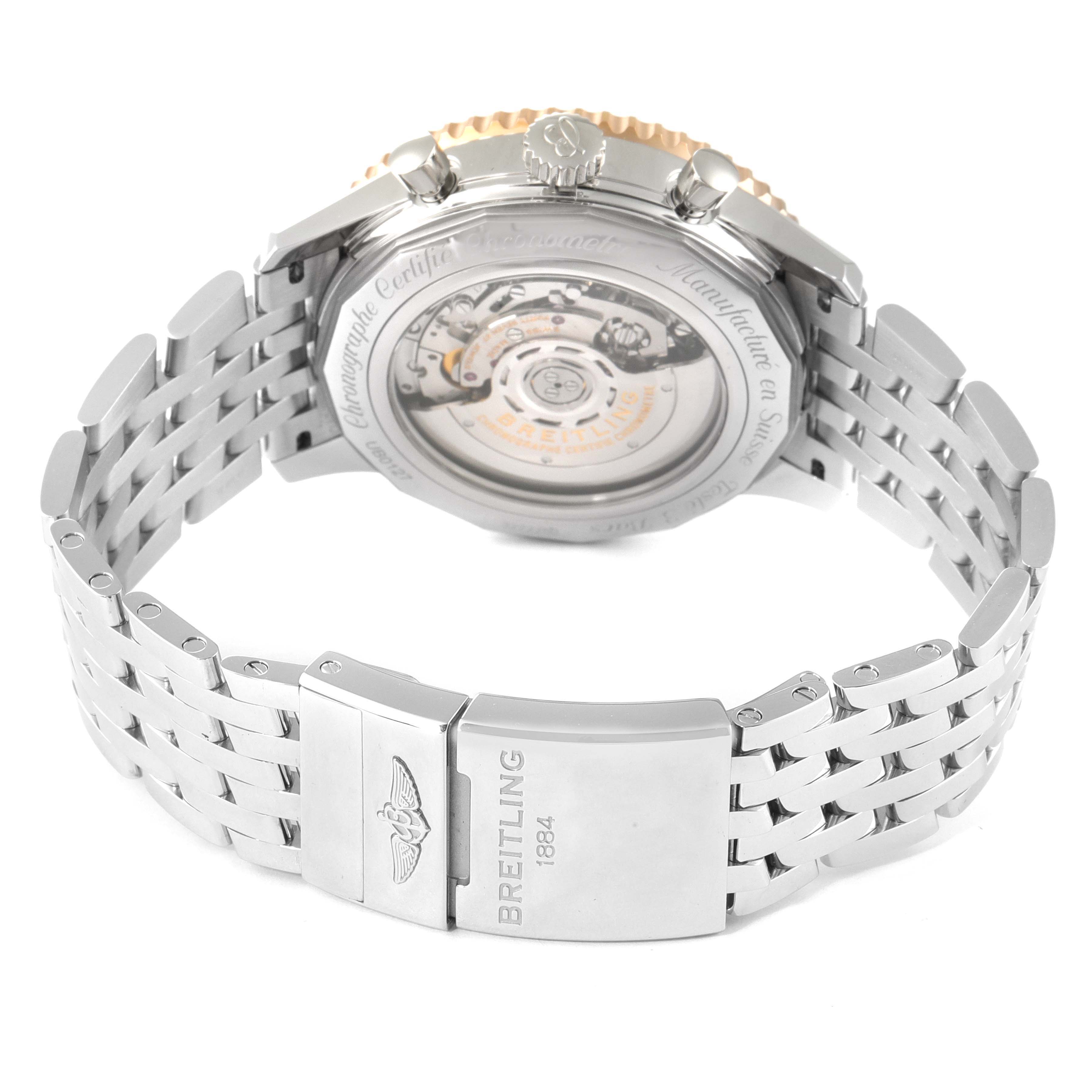 The image shows the back view of a Breitling Navitimer UB0127 Men's Steel and Gold (two tone) Black Dial UB0127 Men's Steel and Gold (two tone) Black Dial watch, featuring its open case back and stainless steel bracelet.