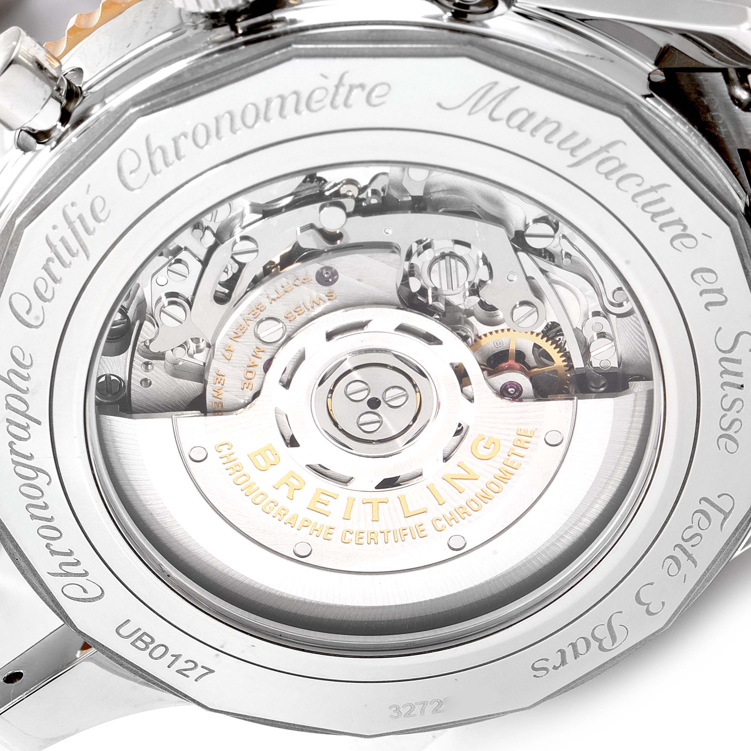 The image shows the back view of a Breitling Navitimer UB0127 Men's Steel and Gold (two tone) Black Dial UB0127 Men's Steel and Gold (two tone) Black Dial watch, displaying the intricate automatic movement and rotor.