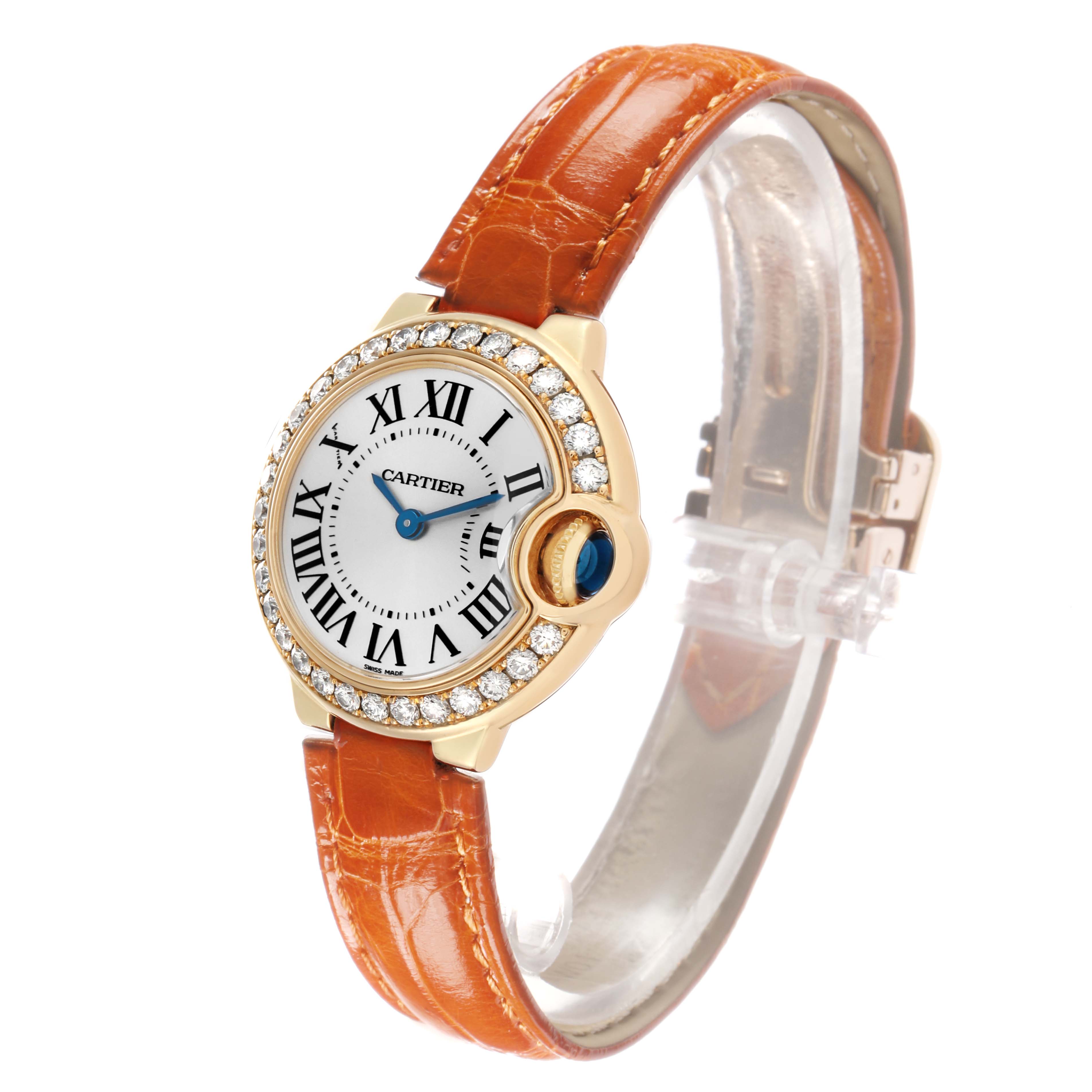 The Cartier Ballon Bleu WE900151 Women's Yellow Gold Silver Dial watch is shown at an angle highlighting the face, diamond bezel, crown, and leather strap.