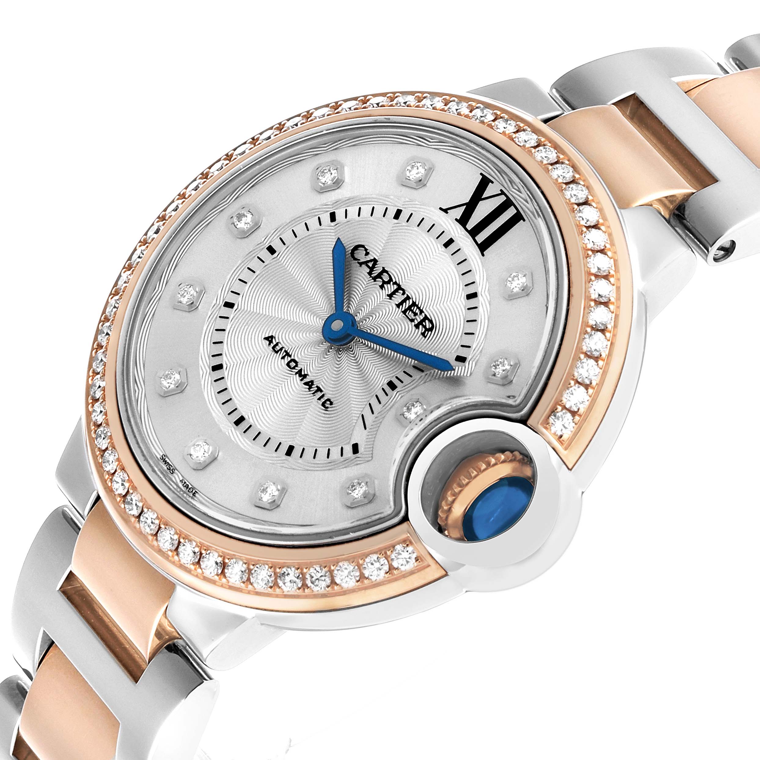 The Cartier Ballon Bleu WE902077 Women's Steel and Gold (two tone) Silver Dial watch is shown at an angled view, highlighting its face, crown, and part of the bracelet.