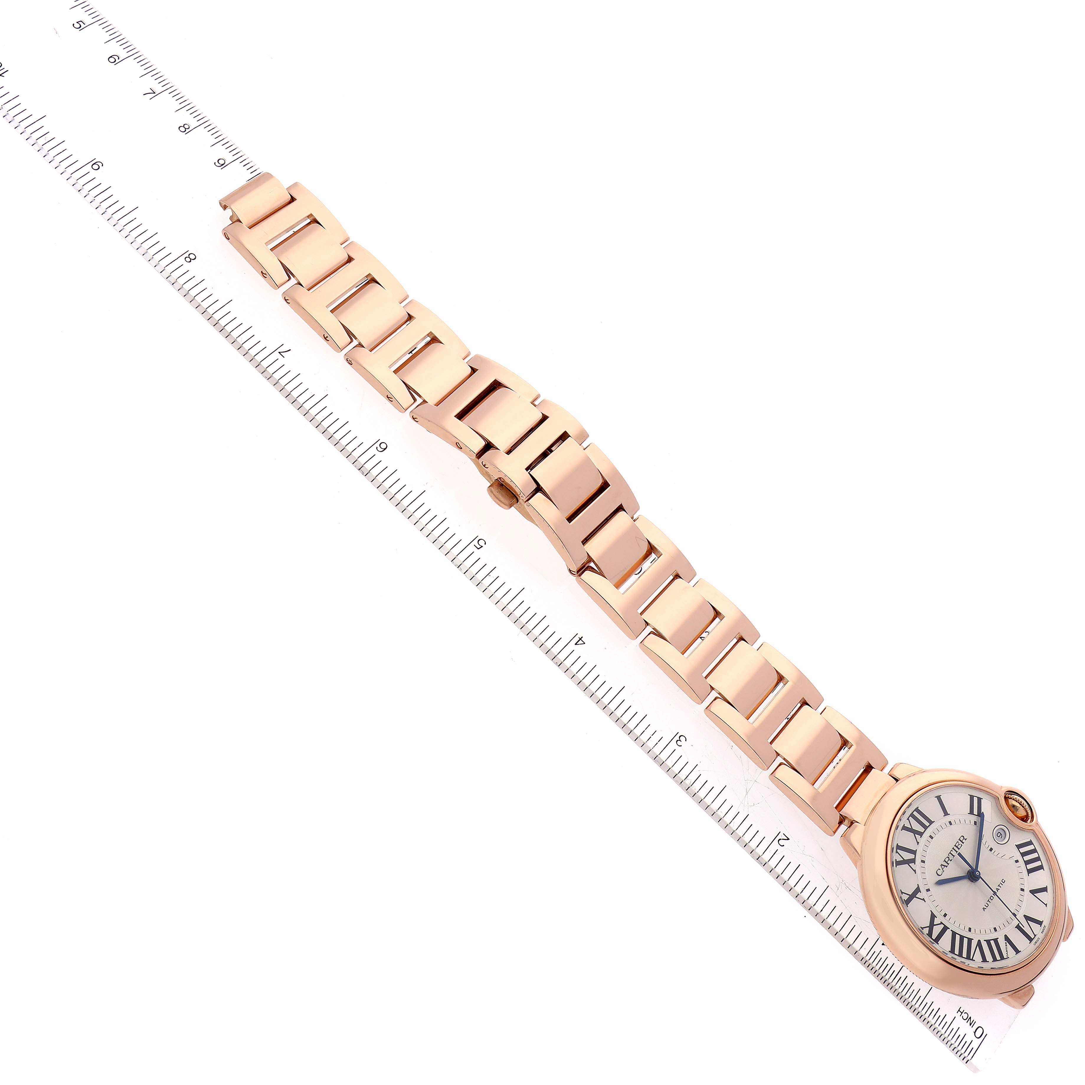 The Cartier Ballon Bleu W69006Z2 Men
s Rose Gold Silver Dial watch is shown from a top-down angle, highlighting the face and the full bracelet against a ruler for scale.