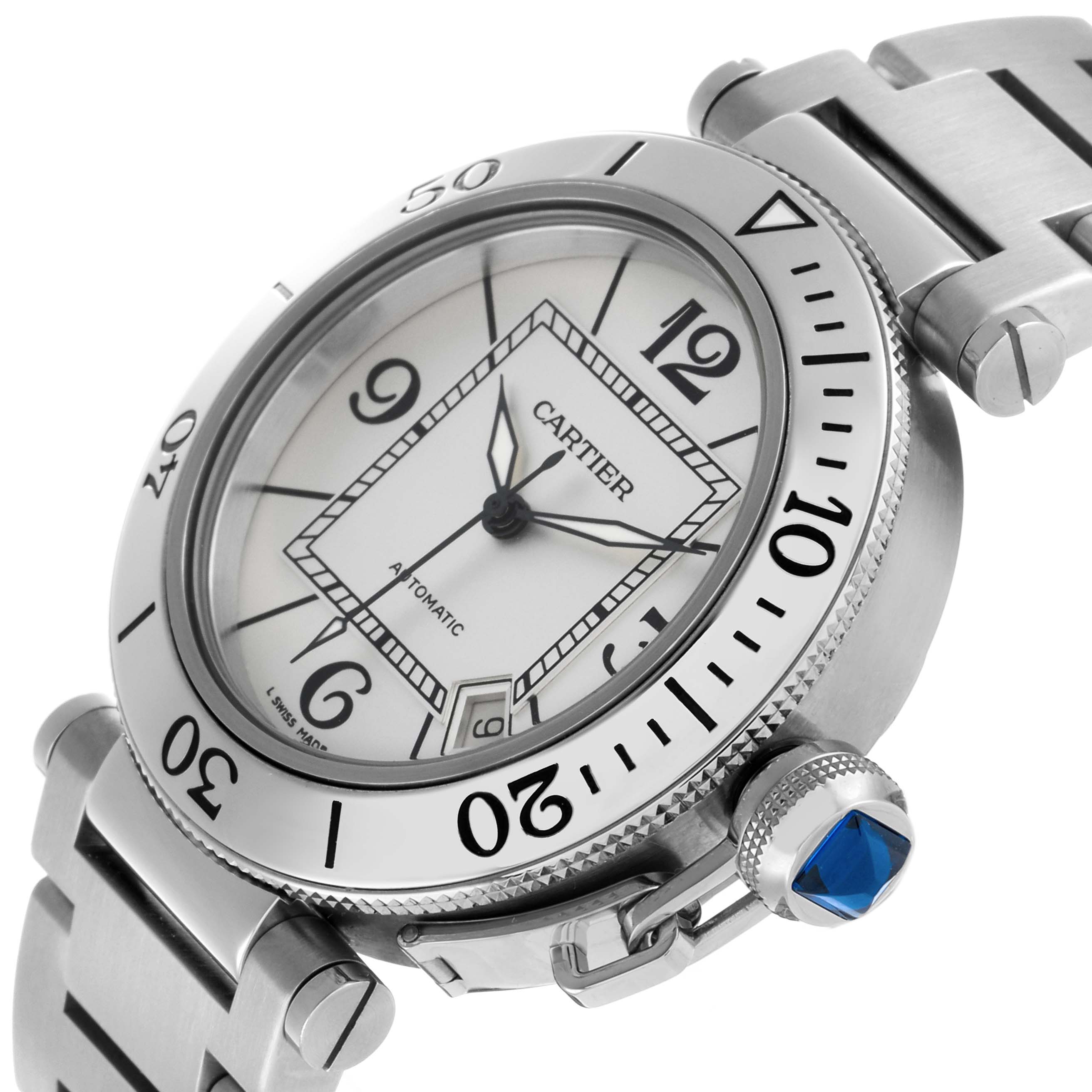 The Calibre de Cartier watch is shown at a three-quarter angle highlighting the dial, bezel, crown, and part of the bracelet.