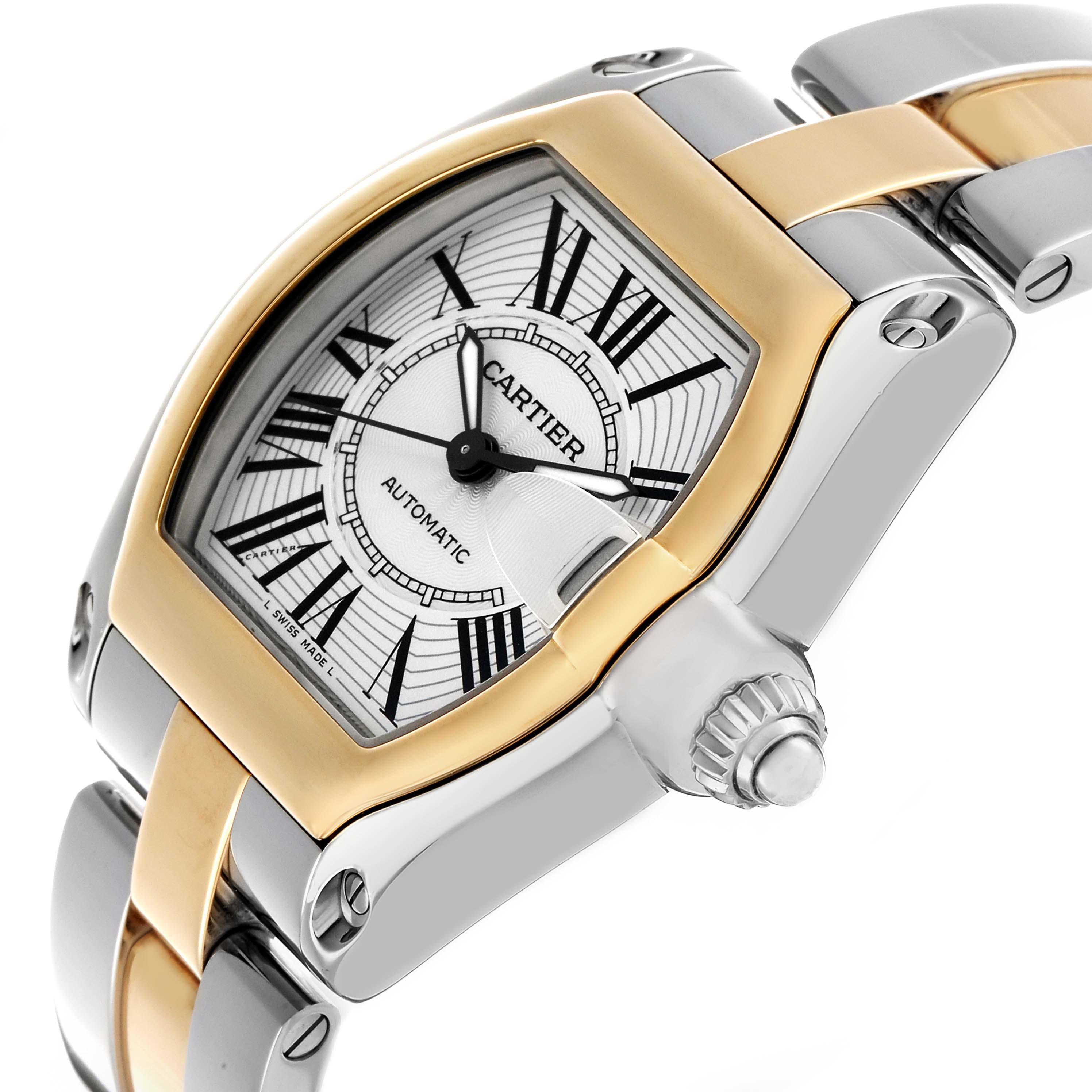 The Cartier Roadster W62031Y4 Men's Steel and Gold (two tone) Silver Dial watch is shown from a tilted angle highlighting its face, bezel, and partial bracelet.