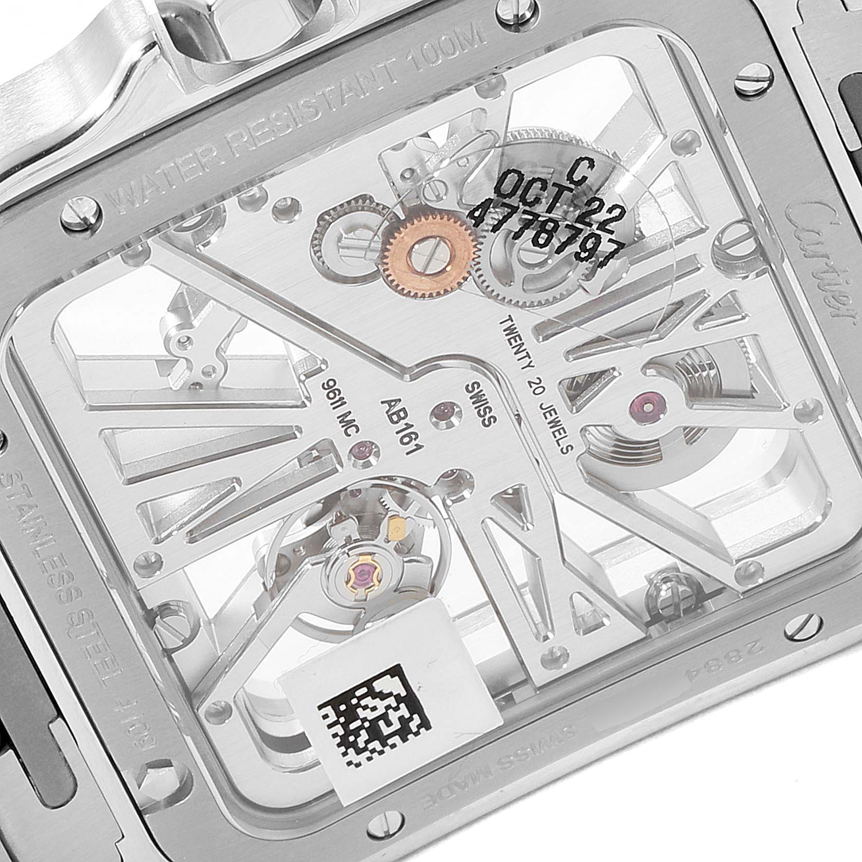 The image shows the detailed back view of the Cartier Santos WHSA0019 Men's Steel and Gold (two tone) Transparent Dial WHSA0019 Men's Steel and Gold (two tone) Transparent Dial watch, highlighting its internal mechanism and inscriptions.