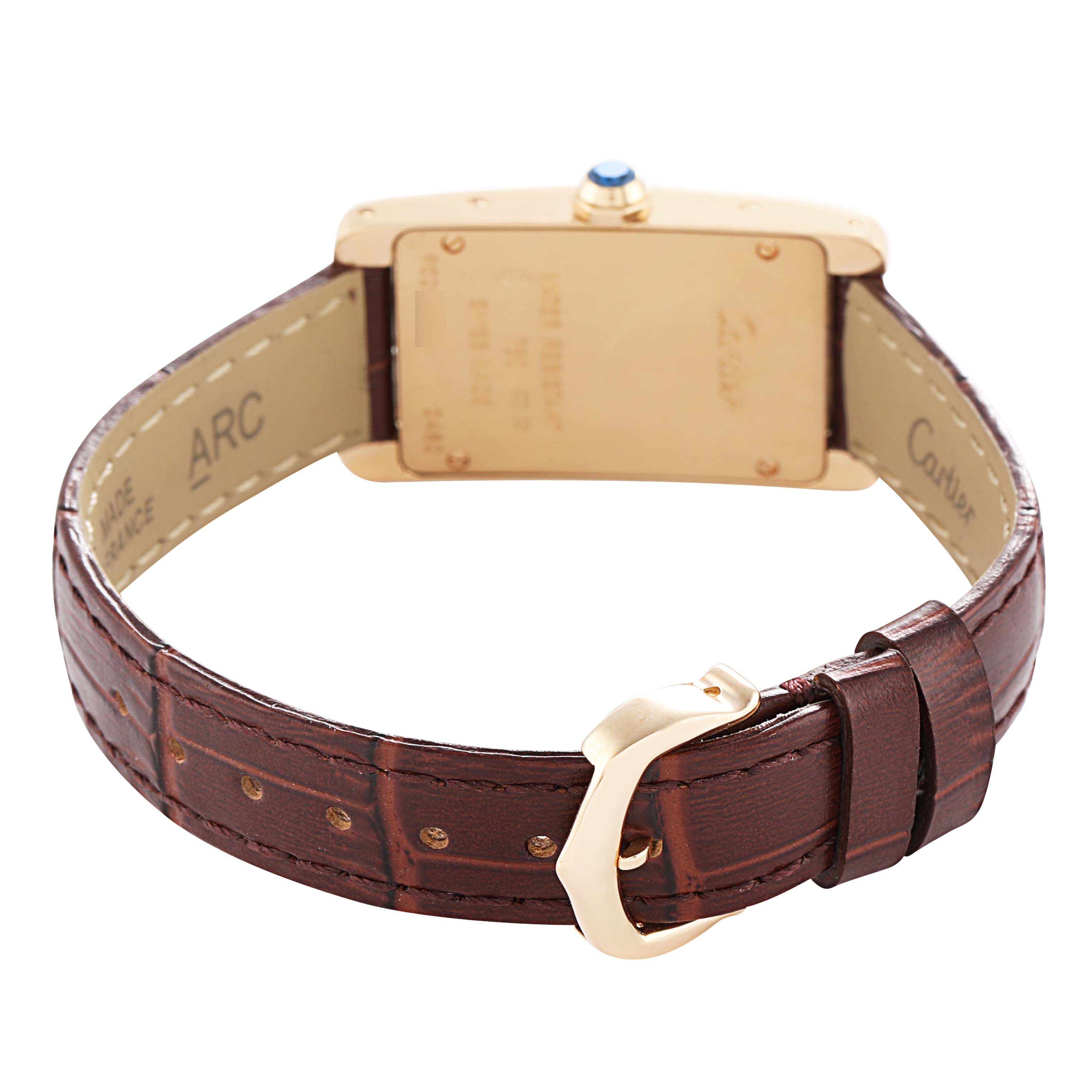 The Cartier Tank Americaine W2601556 Women's Yellow Gold Beige Dial watch is shown from the back, highlighting the case, crown, and brown leather strap with a buckle.