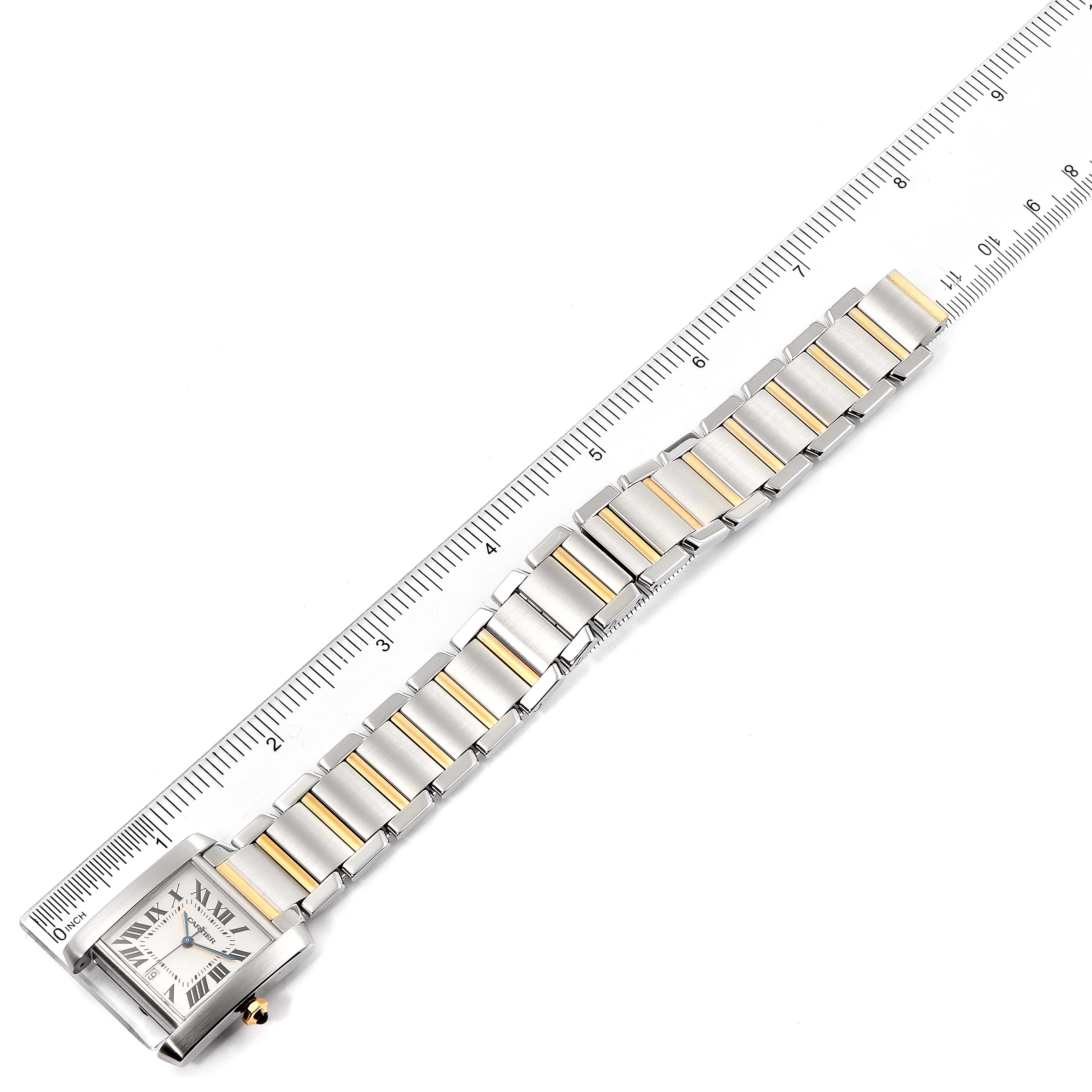 The Cartier Tank Francaise W51005Q4 Men's Steel and Gold (two tone) Silver Dial W51005Q4 Men's Steel and Gold (two tone) Silver Dial watch is shown diagonally, displaying its face, case, and metal bracelet along with a ruler for scale.