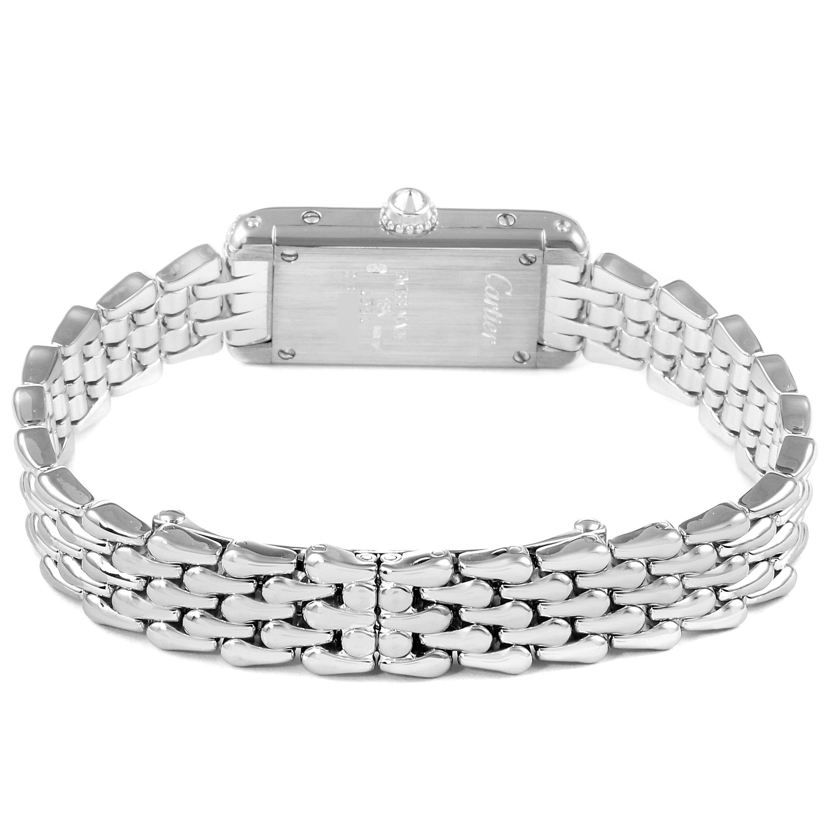 The image shows the back view of a Cartier Tank Americaine 1381 Women's White Gold Silver Dial 1381 Women's White Gold Silver Dial watch, highlighting its stainless steel bracelet and case.