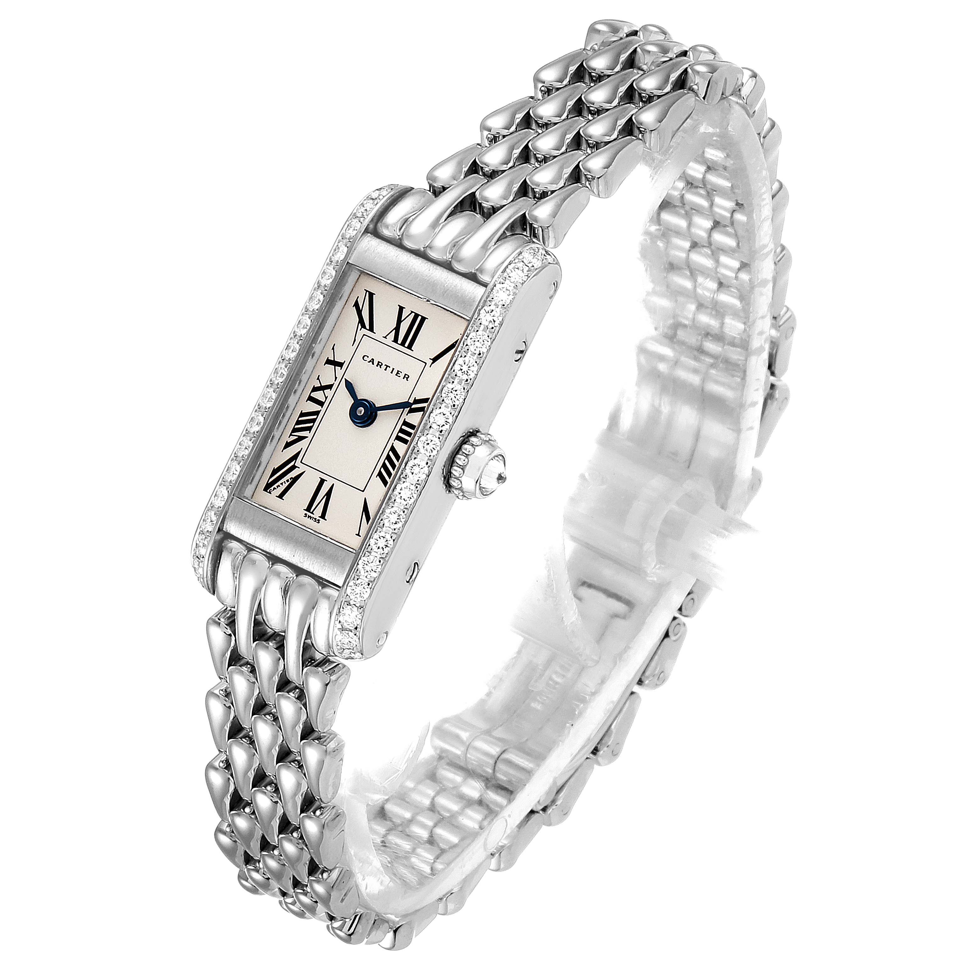 The image shows a Cartier Tank Américaine watch at a three-quarter angle, highlighting its face, bracelet, crown, and bezel adorned with diamonds.