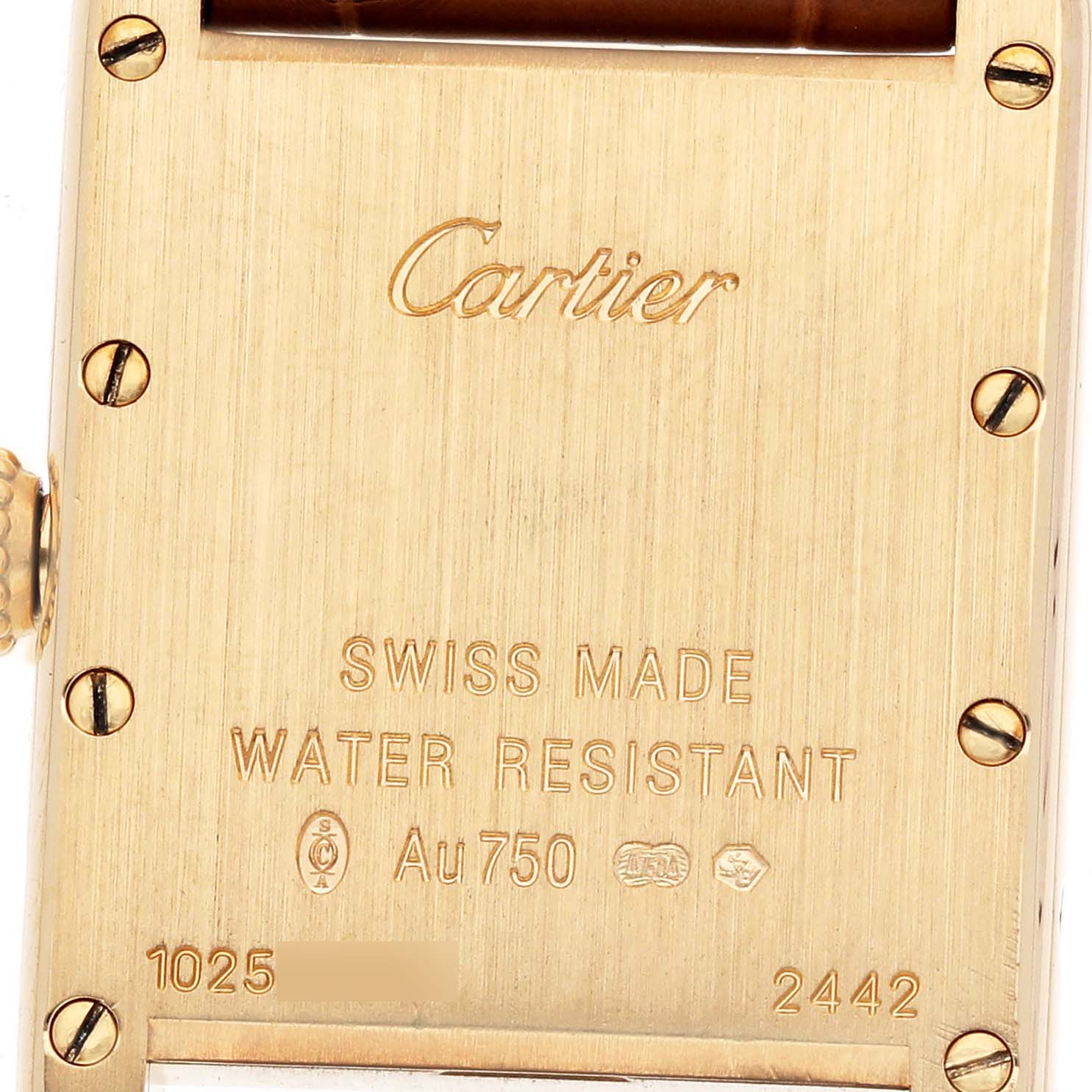 The image shows the back case of the Cartier Tank Louis W1529856 Women's Yellow Gold Beige Dial watch, featuring engravings and screws.
