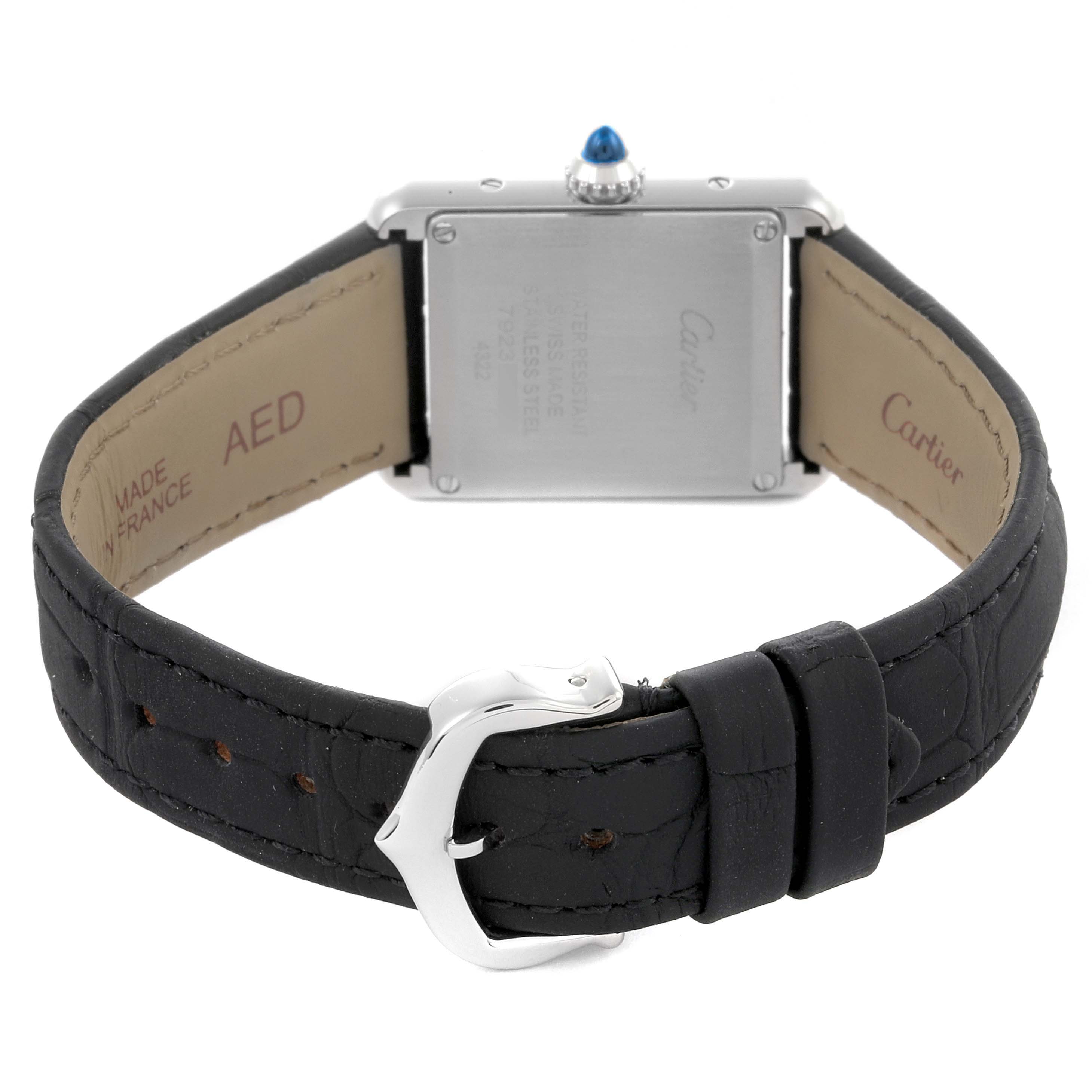 The Cartier Tank Must W4TA0016 Women
s Stainless Steel Silver Dial W4TA0016 Women
s Stainless Steel Silver Dial watch is shown from the back, highlighting the case back, crown, and leather strap with a buckle.