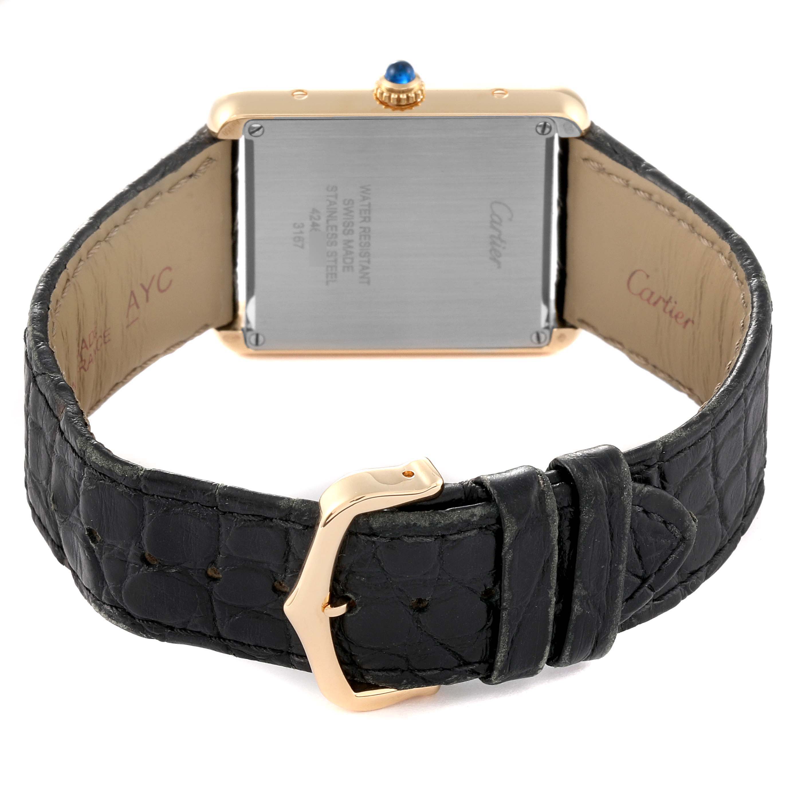 The image shows the back of the Cartier Tank Solo W5200004 Men
s Steel and Gold (two tone) Silver Dial W5200004 Men
s Steel and Gold (two tone) Silver Dial watch and its black leather strap with a gold buckle.