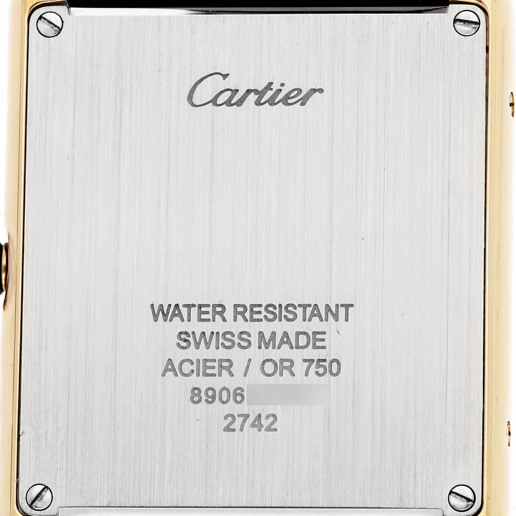 The image shows the back of the Cartier Tank Solo W1018855 Men's Yellow Gold Silver Dial watch, displaying engraving details and screws.