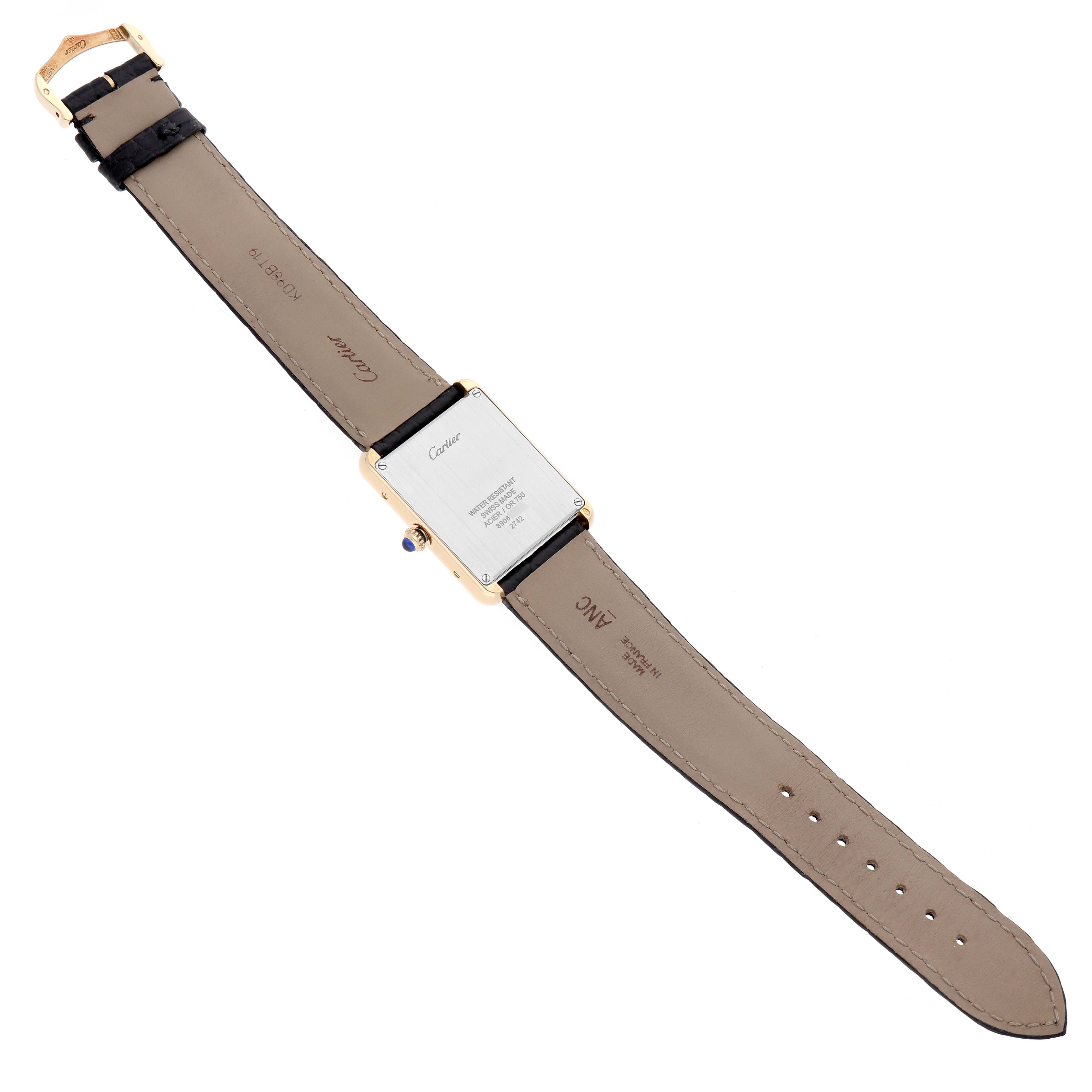 The Cartier Tank Solo W1018855 Men's Yellow Gold Silver Dial watch is shown from the back, displaying the case back, leather strap, and buckle.