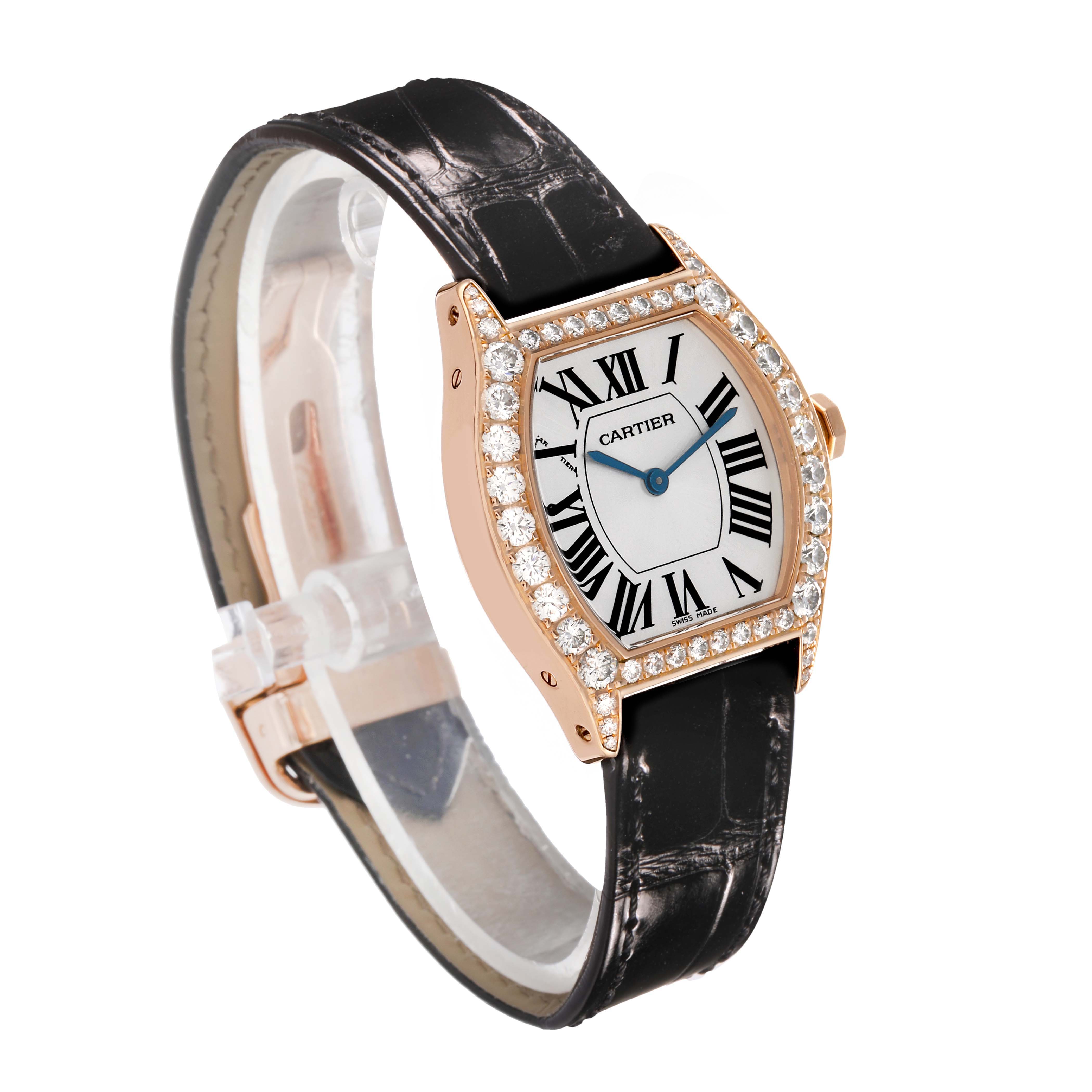The Cartier Tortue WA507031 Women's Rose Gold Silver Dial watch is shown at a three-quarter angle, highlighting its diamond bezel, white dial with Roman numerals, and black strap.
